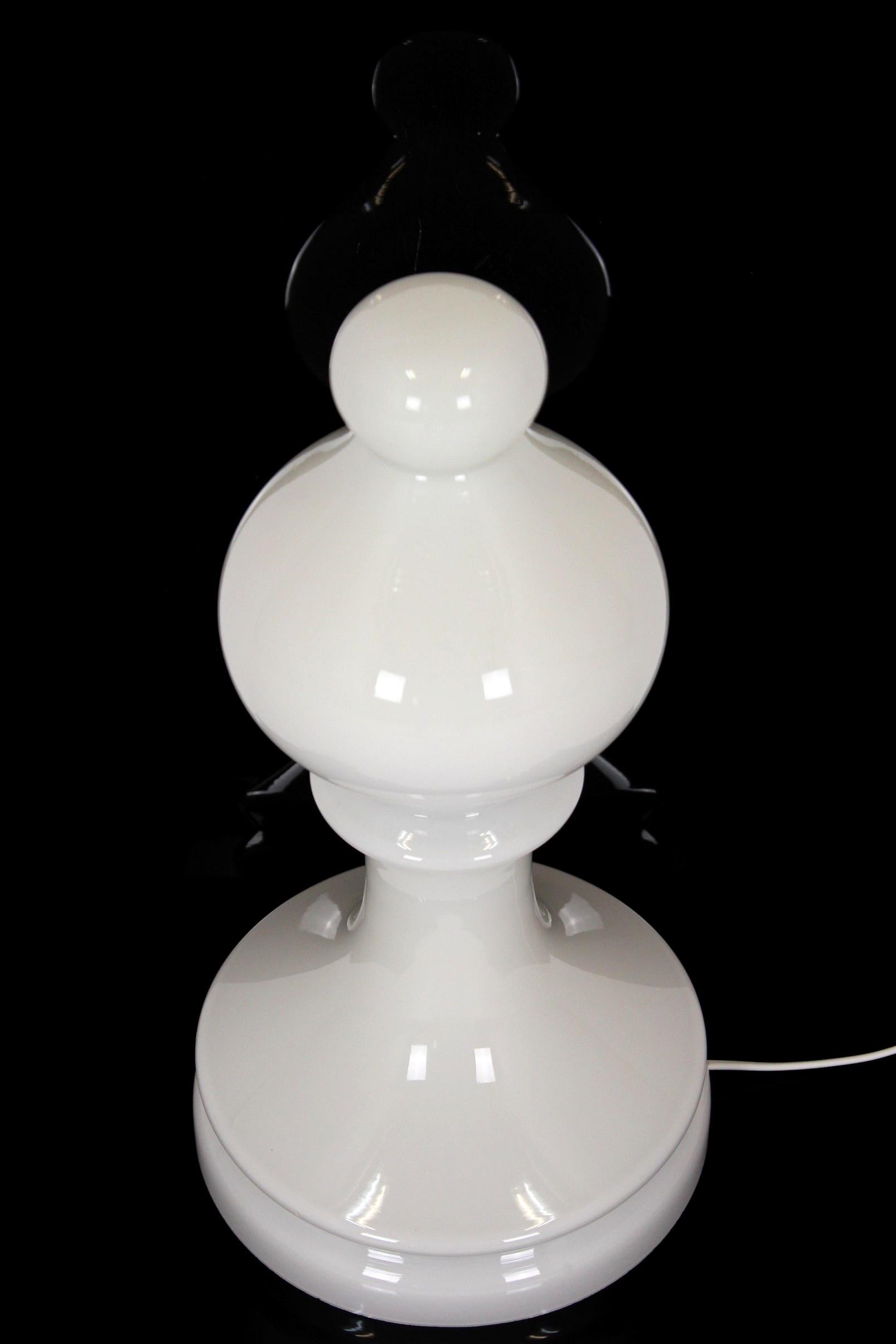 This glass lamp, made of milk white glass in a shape of a chess bishop, was designed by Ivan Jakeš and produced by Osvetlovací Sklo Valašské Mezirící in Czechoslovakia in the 1970s. Lamp in very good vintage condition, fully functional, the cable