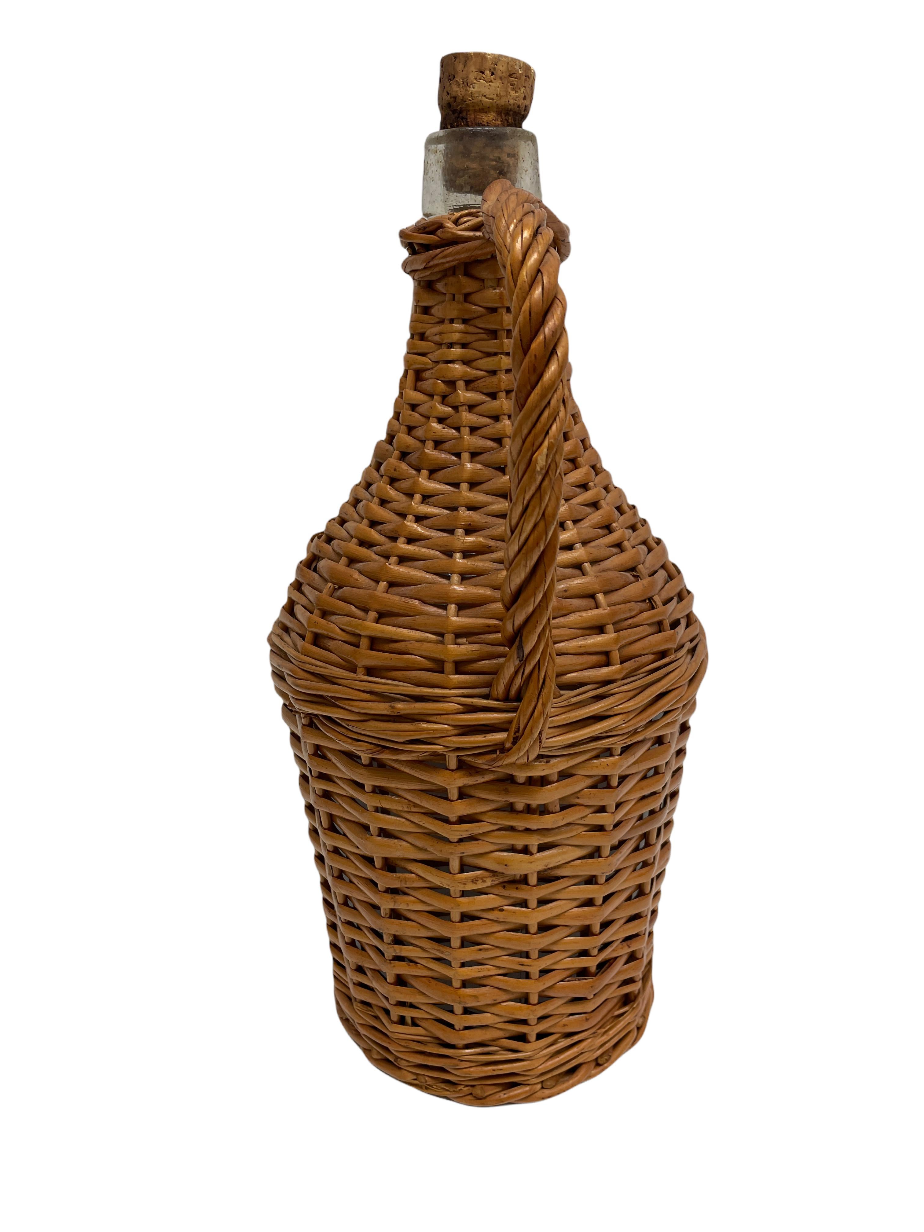 Mid-20th century eye-catching woven basket bottle. Nice addition to your home, patio or garden. This is in used condition, with signs of wear as expected with age and use. A nice addition to every home.