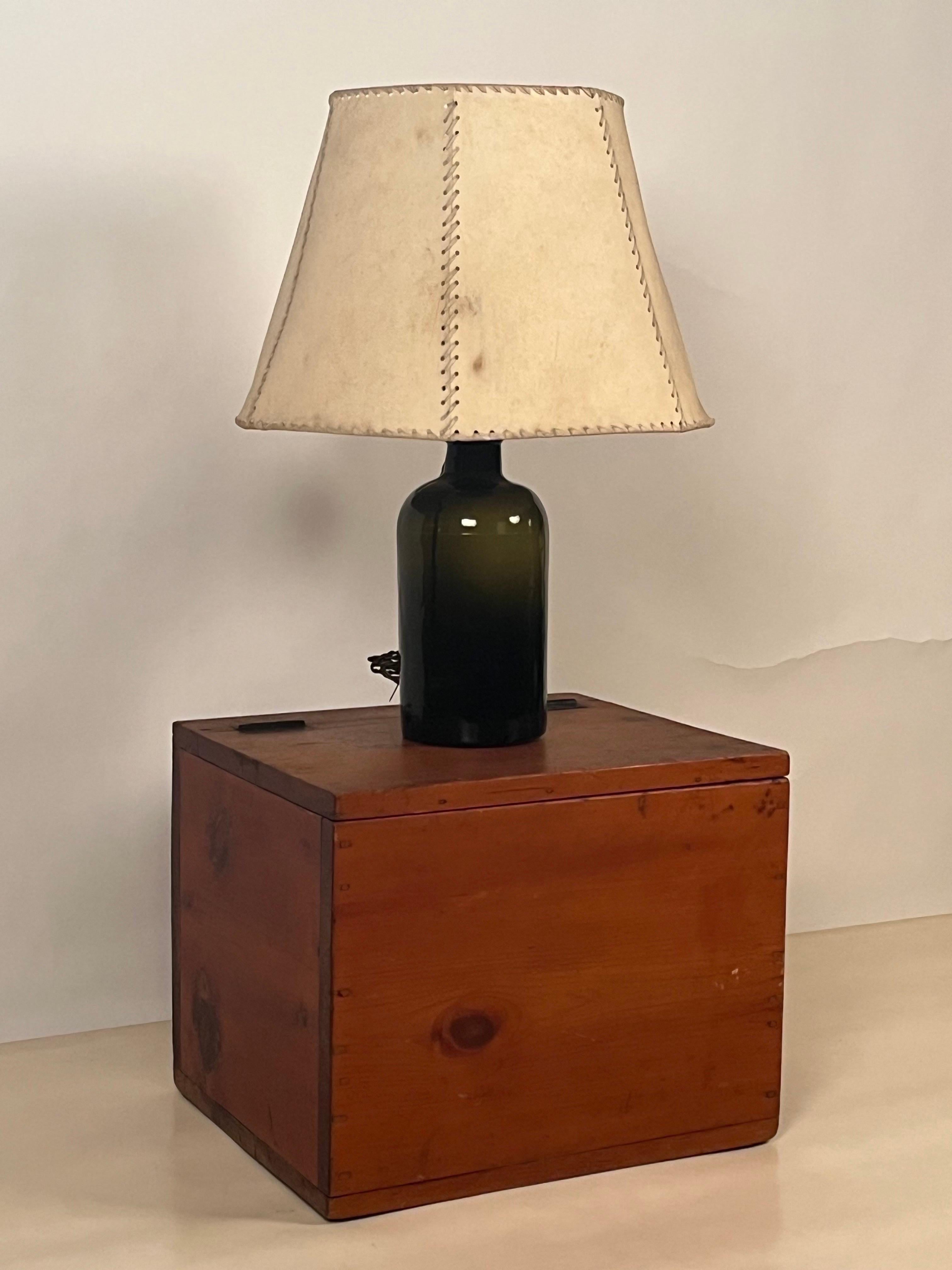 Olive glass bottle and parchment shade lamp with pine box in the style of Luis Barragan.

Lamp (overall dimensions with shade): 20 in. diameter x 27 in. tall
Box: 21 in. wide x 18 in. deep x 17 in. tall

Sold together.