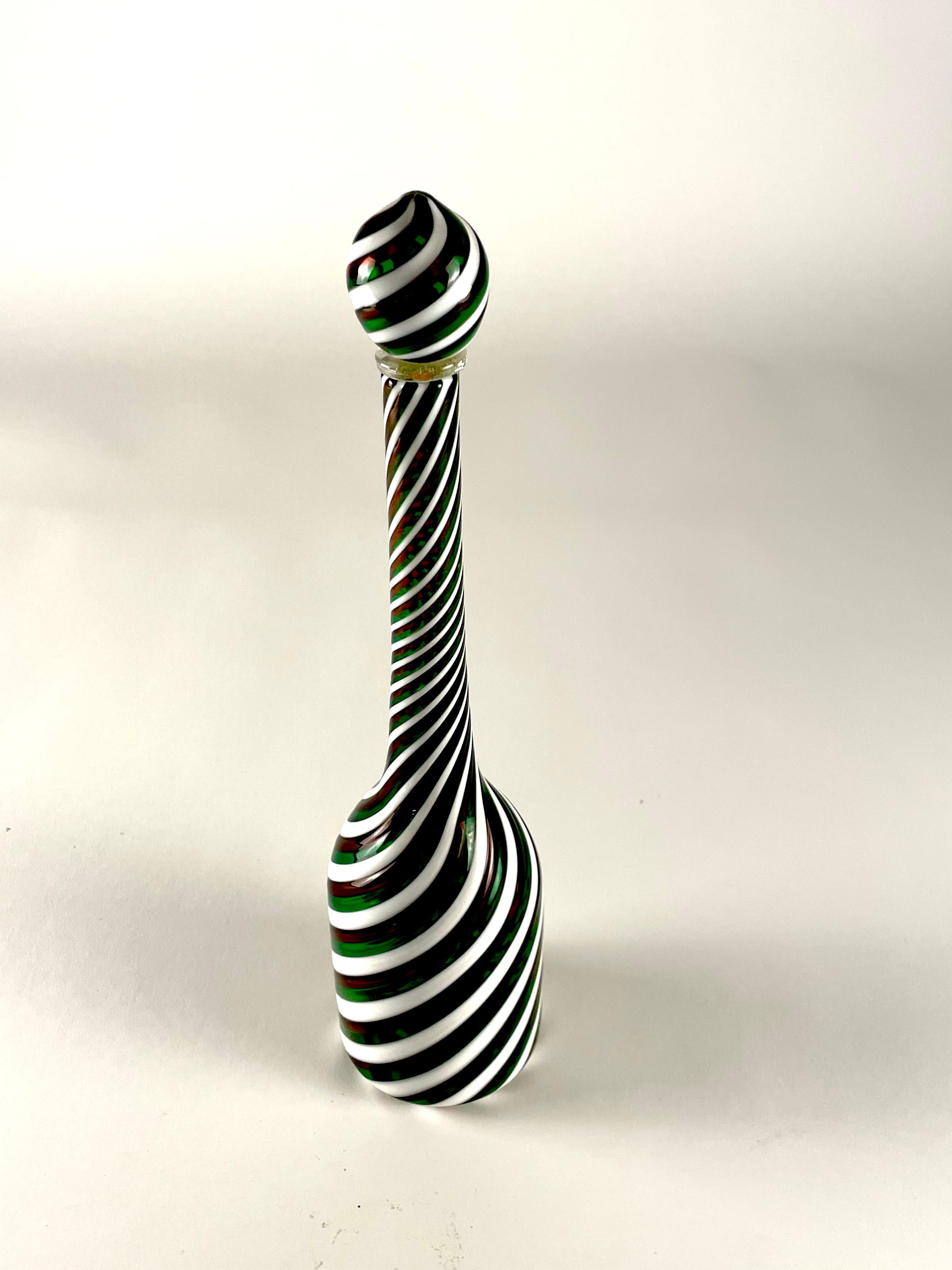 This bottle is handcrafted by renowned maestro Bruno Fornasier for Fratelli Toso glass factory. This stunning piece captures the essence of Murano glass artistry, produced in the '80s; it is realized by using the technique of juxtaposing colored