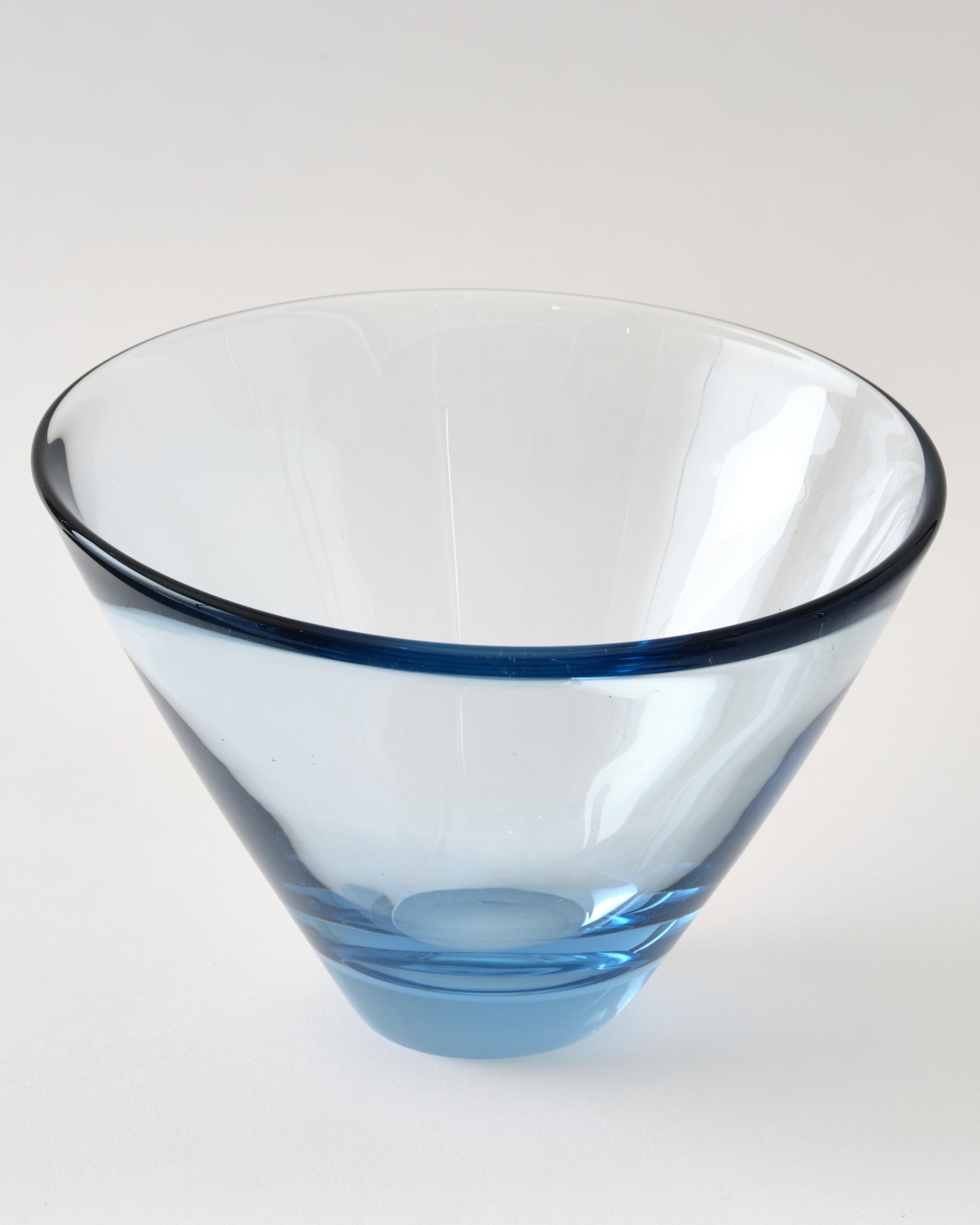 Glass bowl by Holmegaard, Denmark, C 1960, light blue color. The bowl has a beautiful soft round, curvy shape. It is made by hand and it is heavy. 