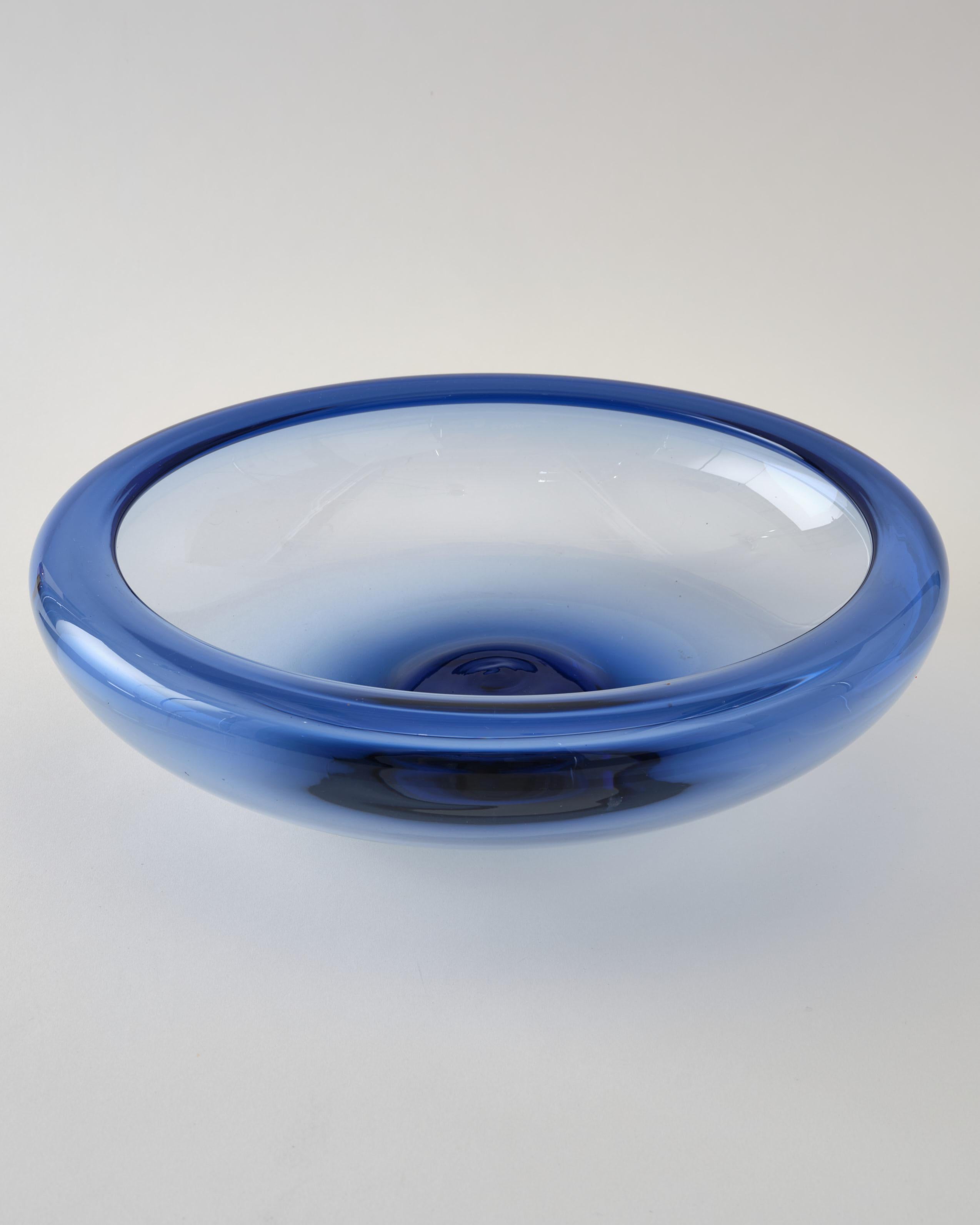 Beautiful round, large glass bowl by Holmegaard, Denmark, C 1960. The bowl is signed. It has a light blue color, like the sky on a sunny day.
It is in a very good condition.