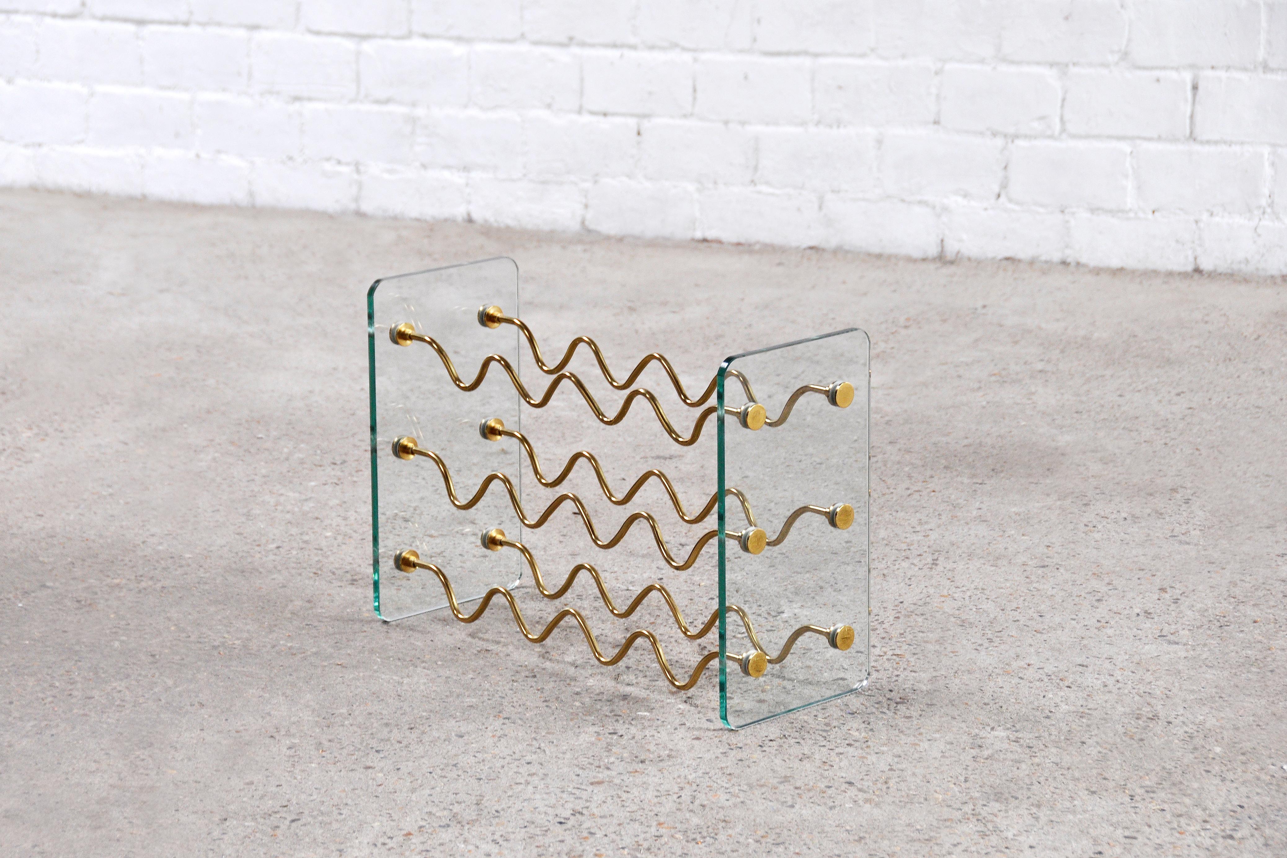 Very decorative wine rack by David Lange, France 1970's. This wine rack has a combination of glass and brass which makes it look classy and chique. There are two pieces available for the option to create an extended rack. Remains in good condition