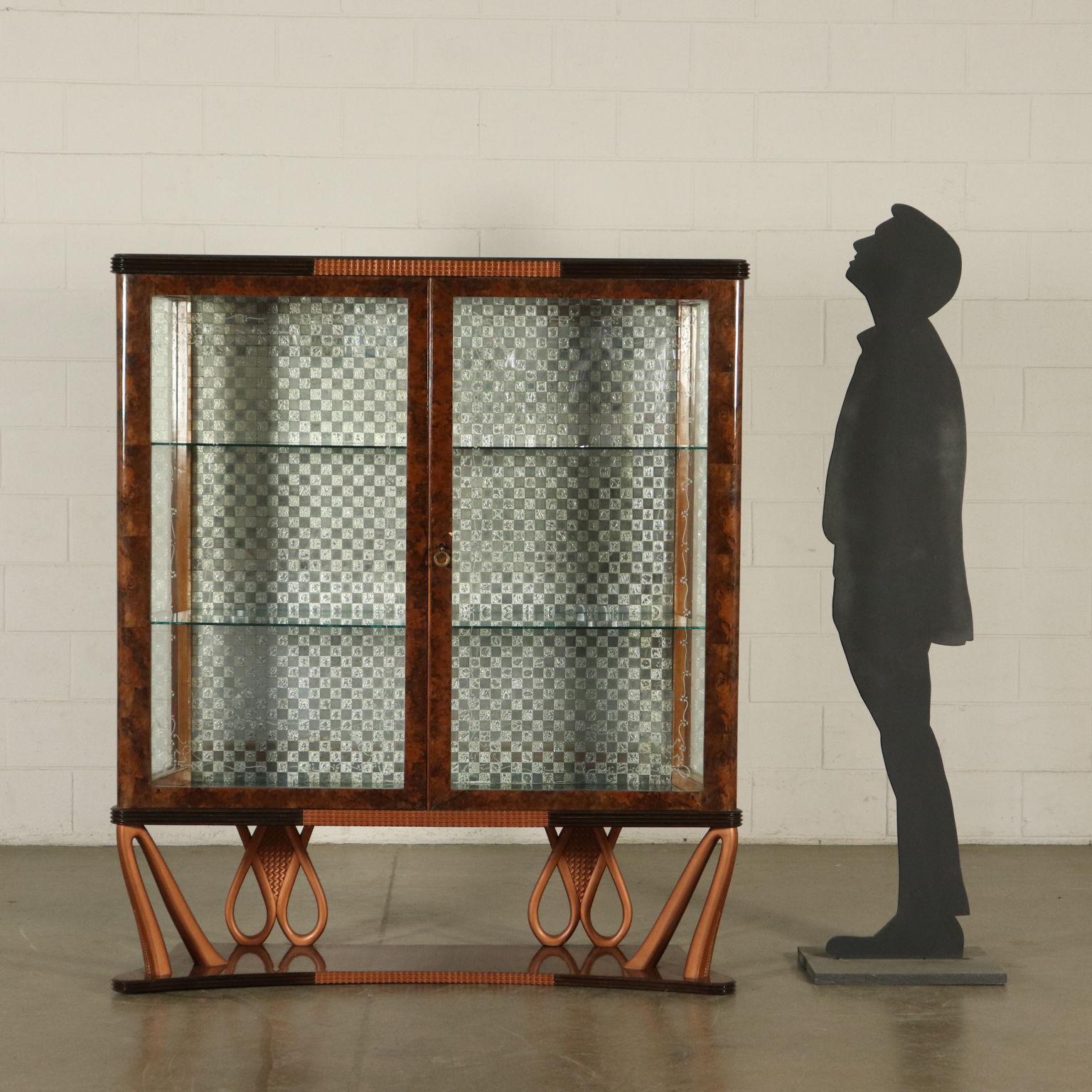 Glass cabinet, burl and wood veneer. Carved geometrical ornaments, bronzed lacquers, interiors with mirrored tiles, glass shelves. Manufactured in Italy, 1940s.