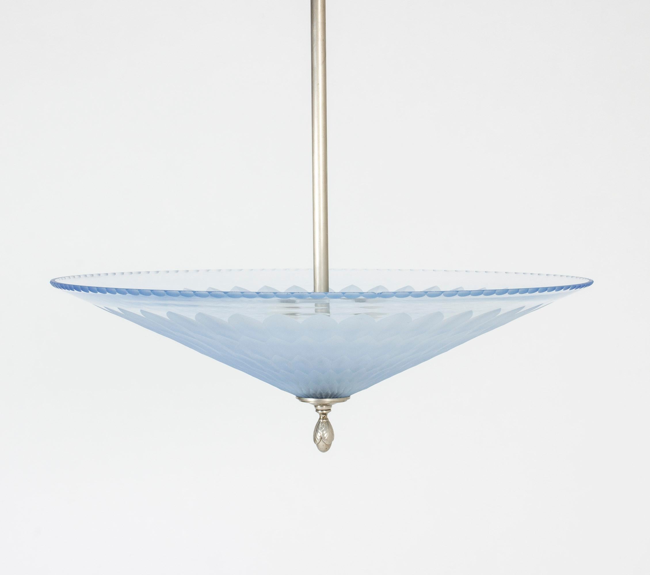 Exquisite ceiling lamp by Edward Hald, made from brushed steel and blue glass. Beautiful cut pattern and scalloped edge. One small chip in the edge.