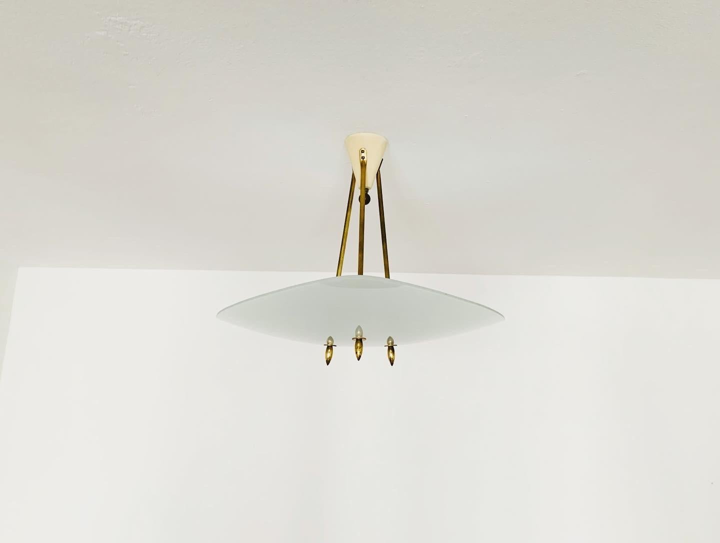 Exceptionally beautiful ceiling lamp from the 1950s.
Very fine and beautiful design which fits wonderfully into any room.
A very noble light is created.

Condition:

Very good vintage condition with slight signs of wear consistent with