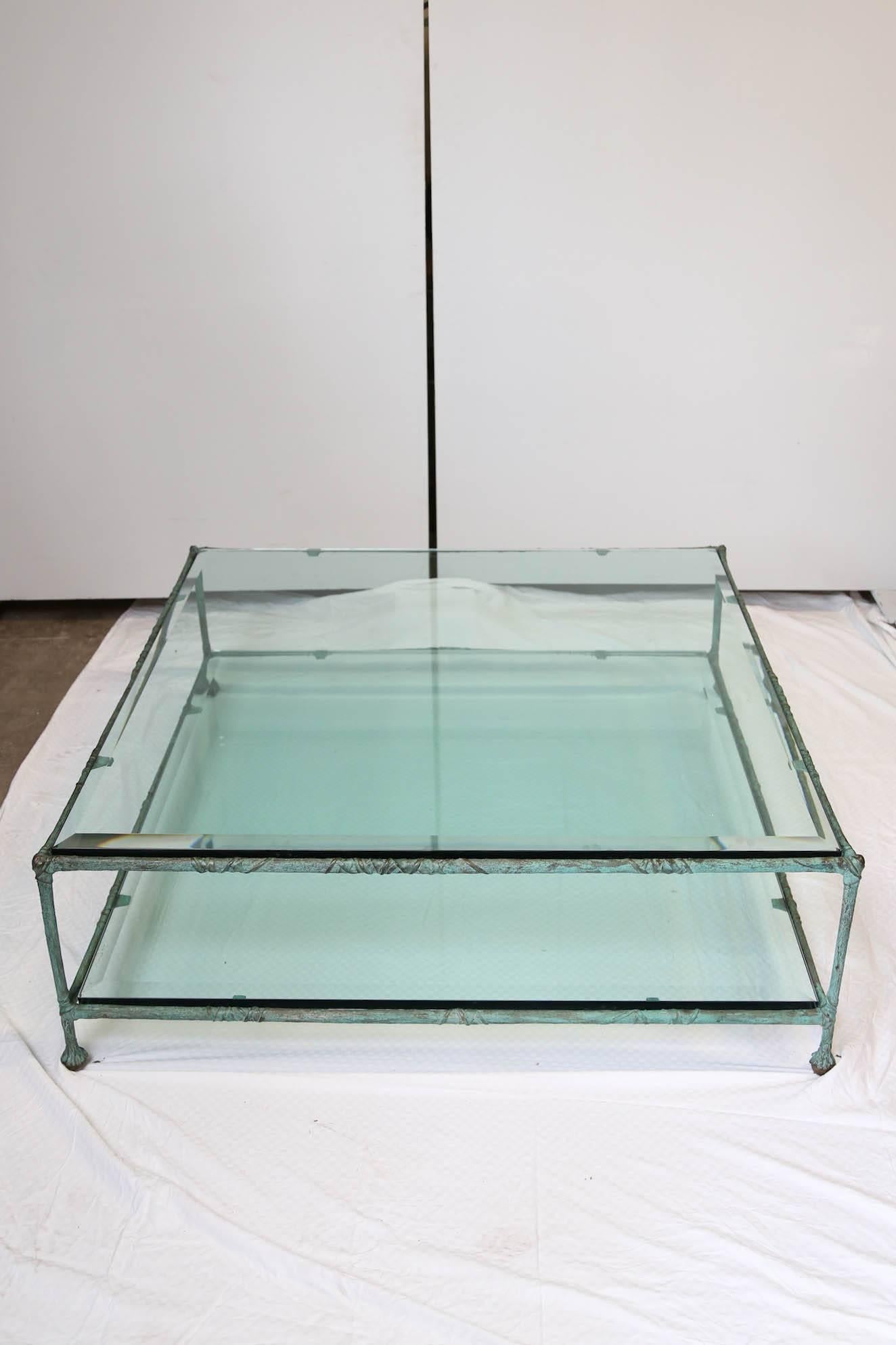 Two levels Mid-Century Modern coffee table with two thick square glass pieces (the bottom one has some minor scratches - see pictures - that cannot be seen unless you look at it very closely). 
The frame is made of bronze in the style of Alberto