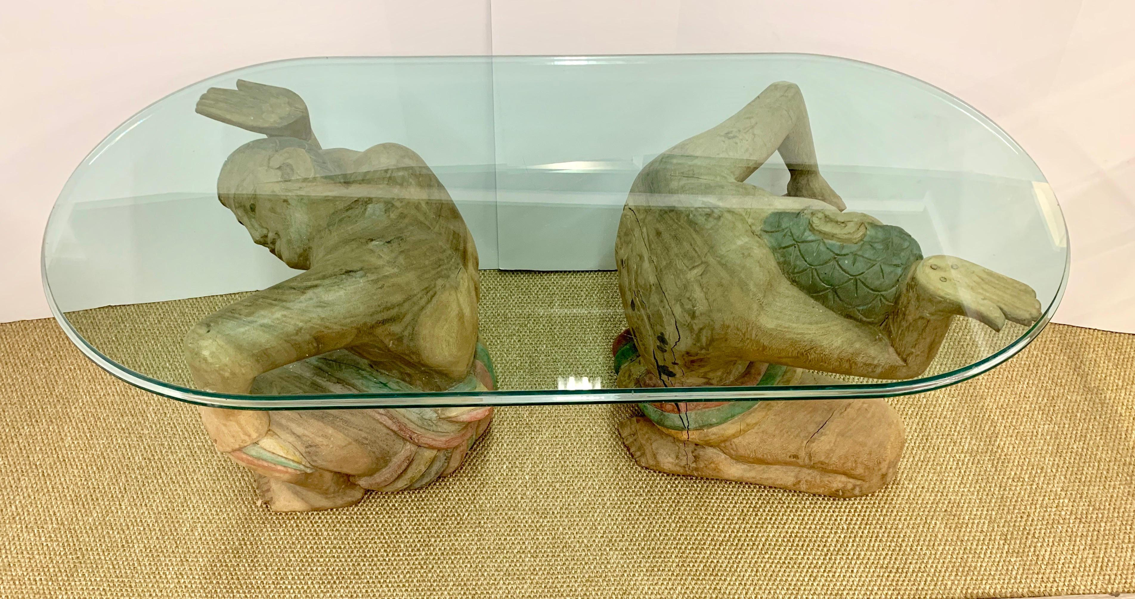 Oval glass top table with unusual figural men base, two men total, all carved in wood.
Most of these sought after tables have one kneeling man at base, this one has two.
