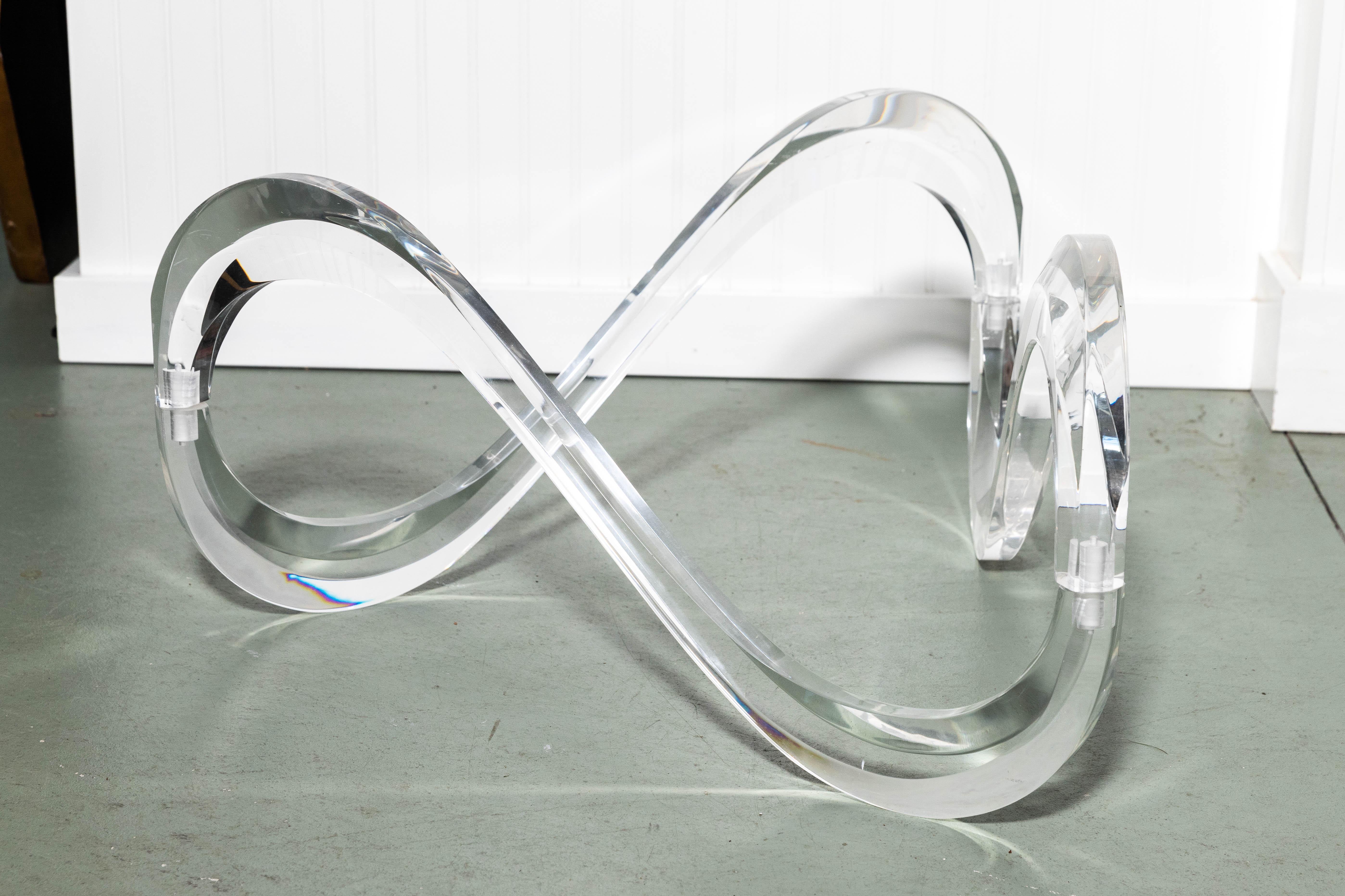 Bevelled glass coffee table with serpentine Lucite base, the base comes in three sections which locks together. This table is very much in keeping with the style of Charles Hollis Jones.
