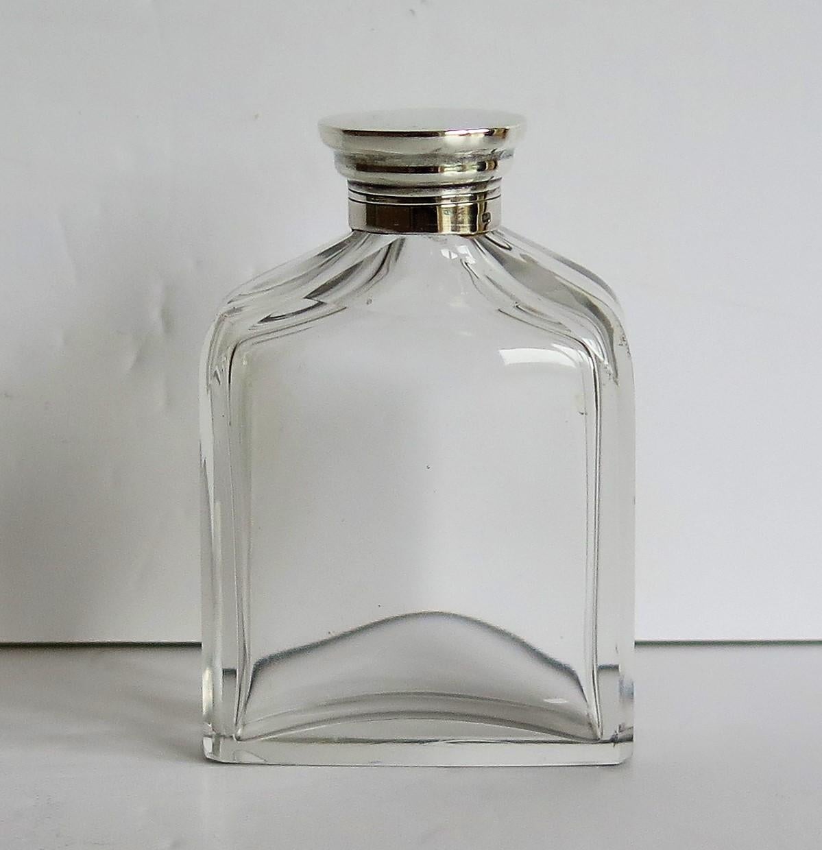 This is a good quality, very attractive crystal cut glass cologne or perfume bottle with a sterling silver screw top lid, possibly American, which we date to the early 20th century.

The clear glass bottle or jar has a rectilinear shape with a
