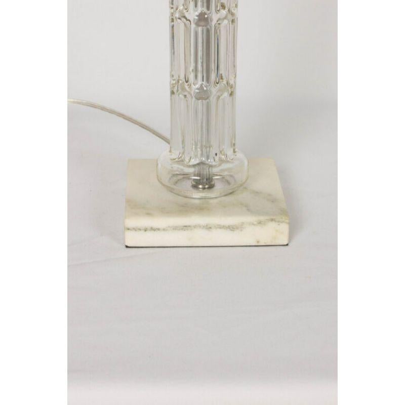 Glass column table lamp with a white marble base. Completely restored. Glass and base have been cleaned and all metal restored. New socket and wiring. C. 1930.

Dimensions: 
Height: 19?
Width: 5?
Depth: 5?