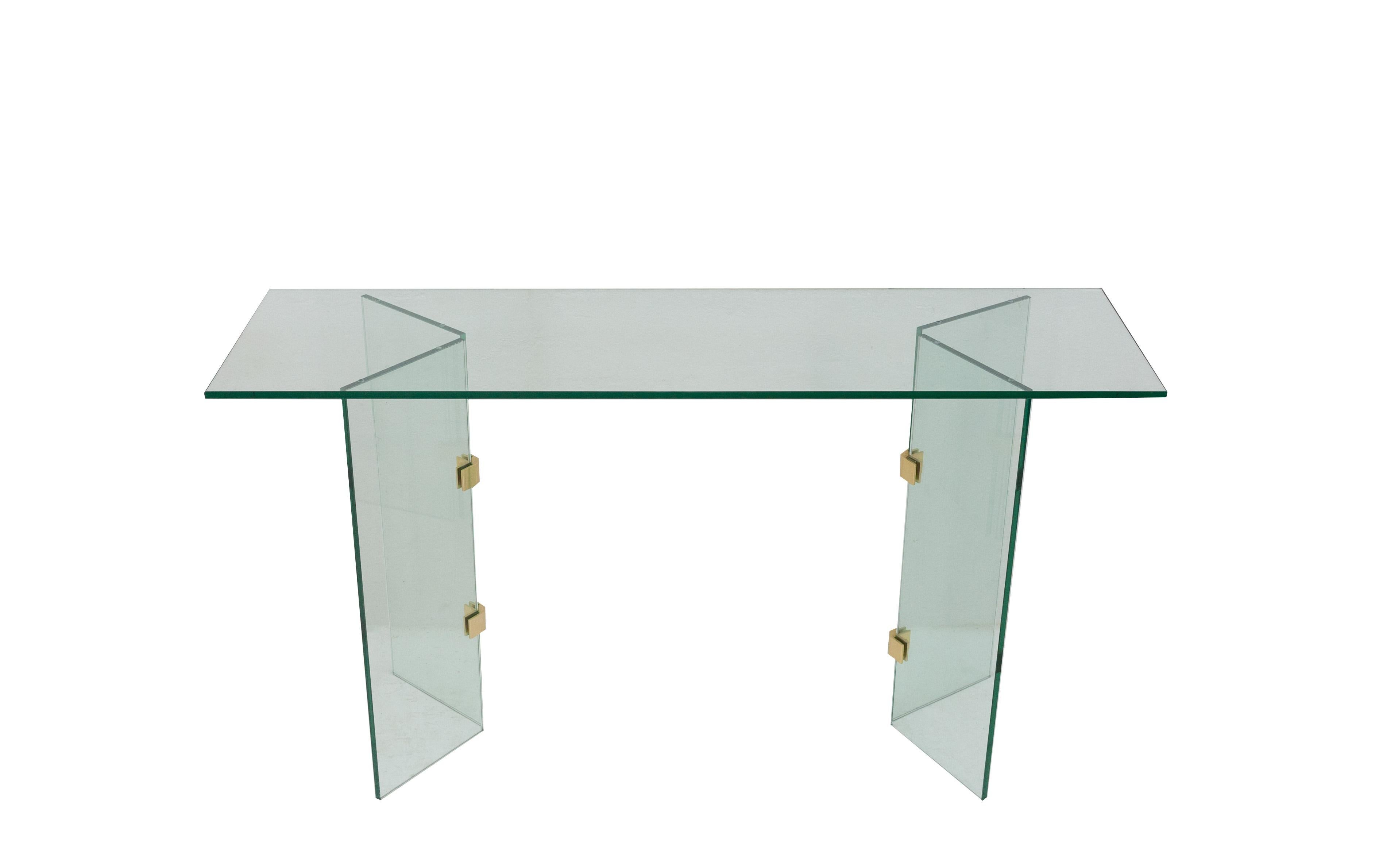 Stunning glass console table in the style of Leon Rosen for Pace collection. Thick glass with brass hardware. The hard-edged glass corners give this table a modern appearance. Very good condition.