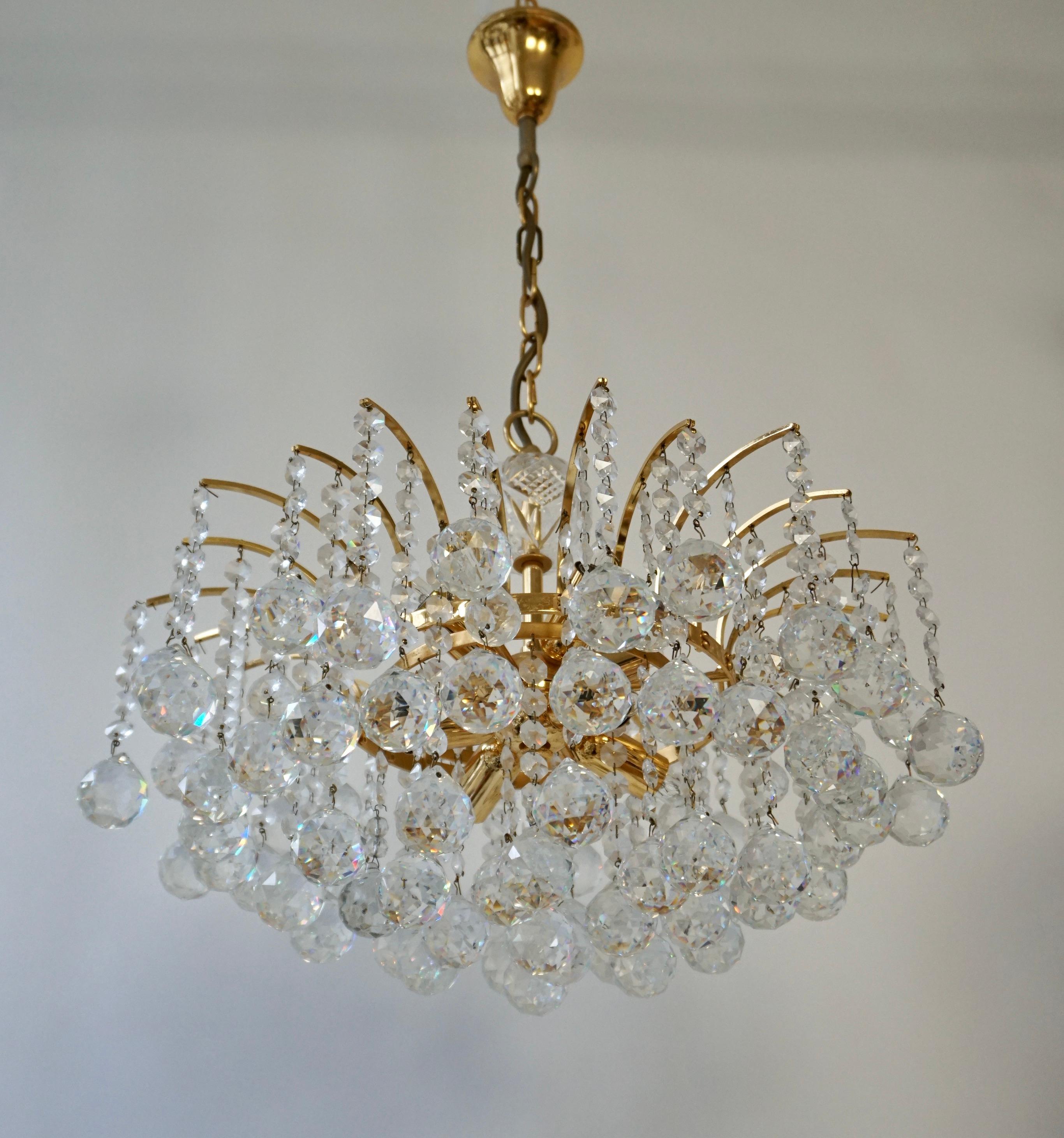 A stunning chandelier, made by Palwa, Germany, circa 1970-1979. It’s composed of Murano teardrop Crystal glass pieces on a gilded brass frame. Best of the 1970s from Germany.   

It is possible to install this fixture in all countries (US, UK,