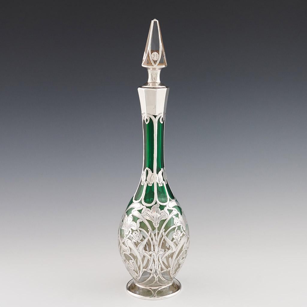“Glass Decanter” American Green Glass Decanter with Silver overlay by Gorham - circa 1905.

A charming early 20th Century American green glass decanter overlaid with silvered Art Nouveau design with central cartouche panel engraved with initials,