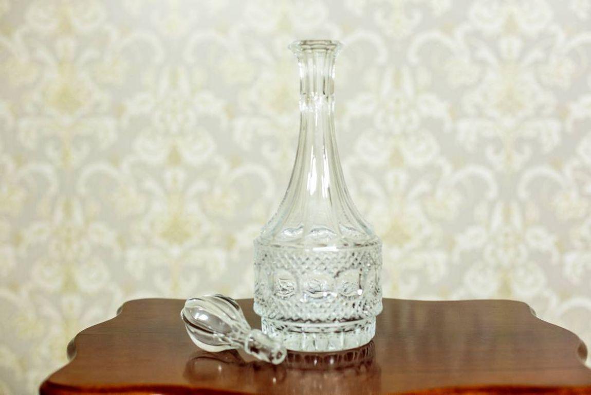 A slender, glass decanter from the 1970s.

Measures: Height 38 cm
Width 13 cm.