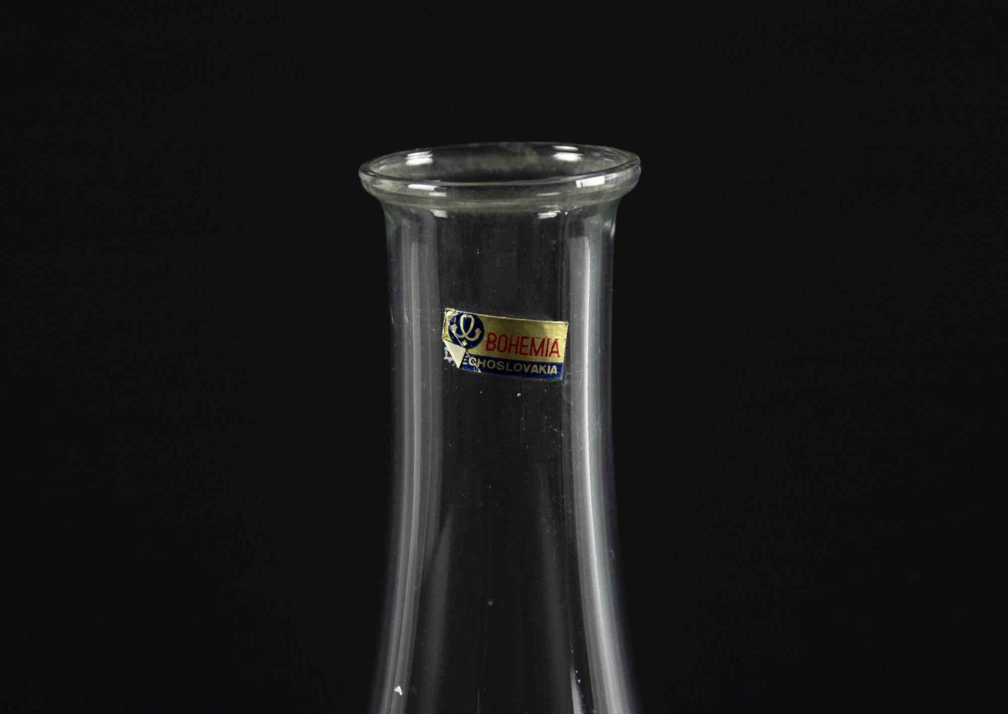Glass decorated bottle is an original object realized in the 1970s.

Original art glass.

Made in Bohemia.

The original label is also present on the surface 