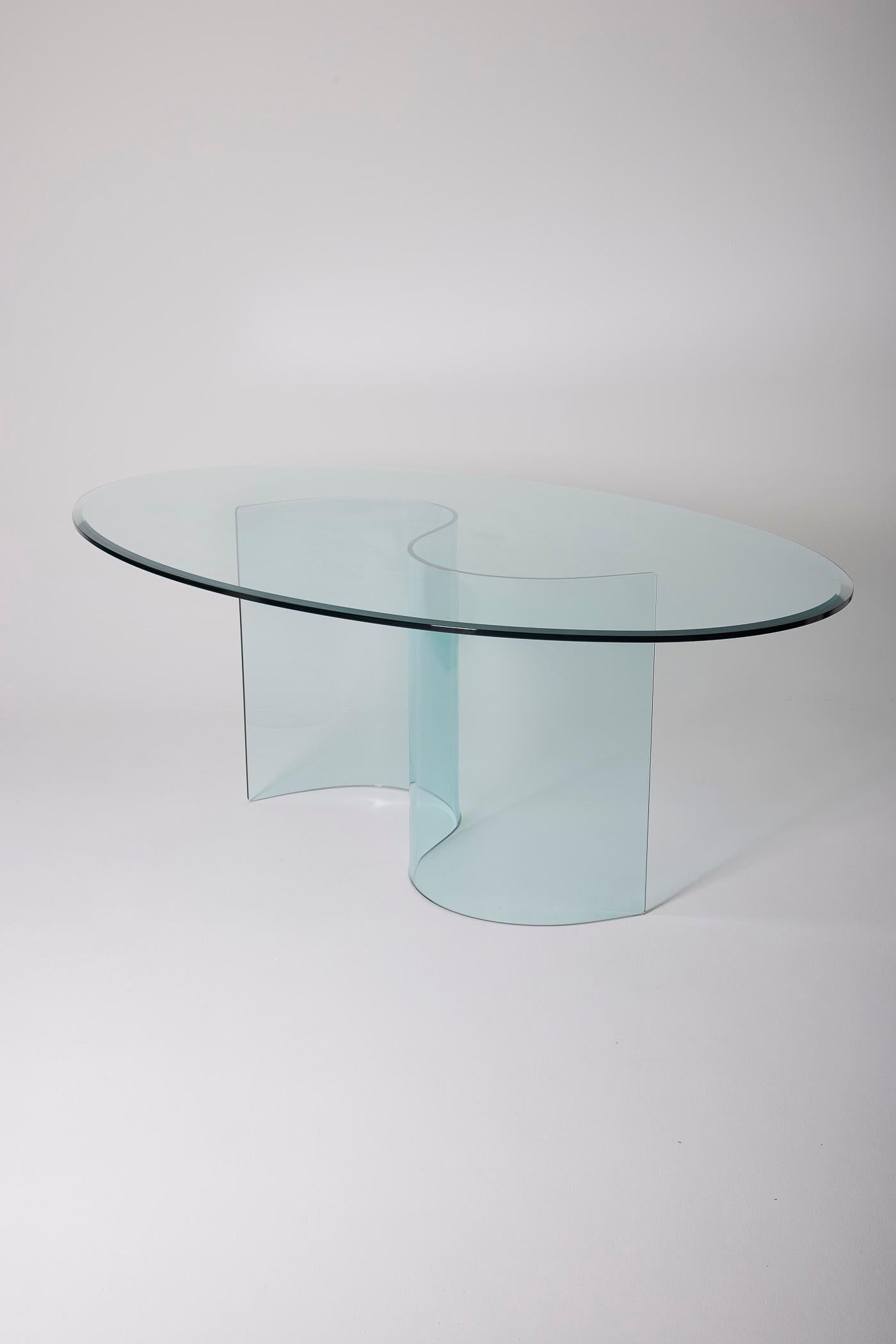 Glass dining table in the spirit of the 70s. The tabletop is oval and the base is S-shaped. This table is a perfect match for furniture by Marcel Breuer or Charlotte Perriand. 
LP1558