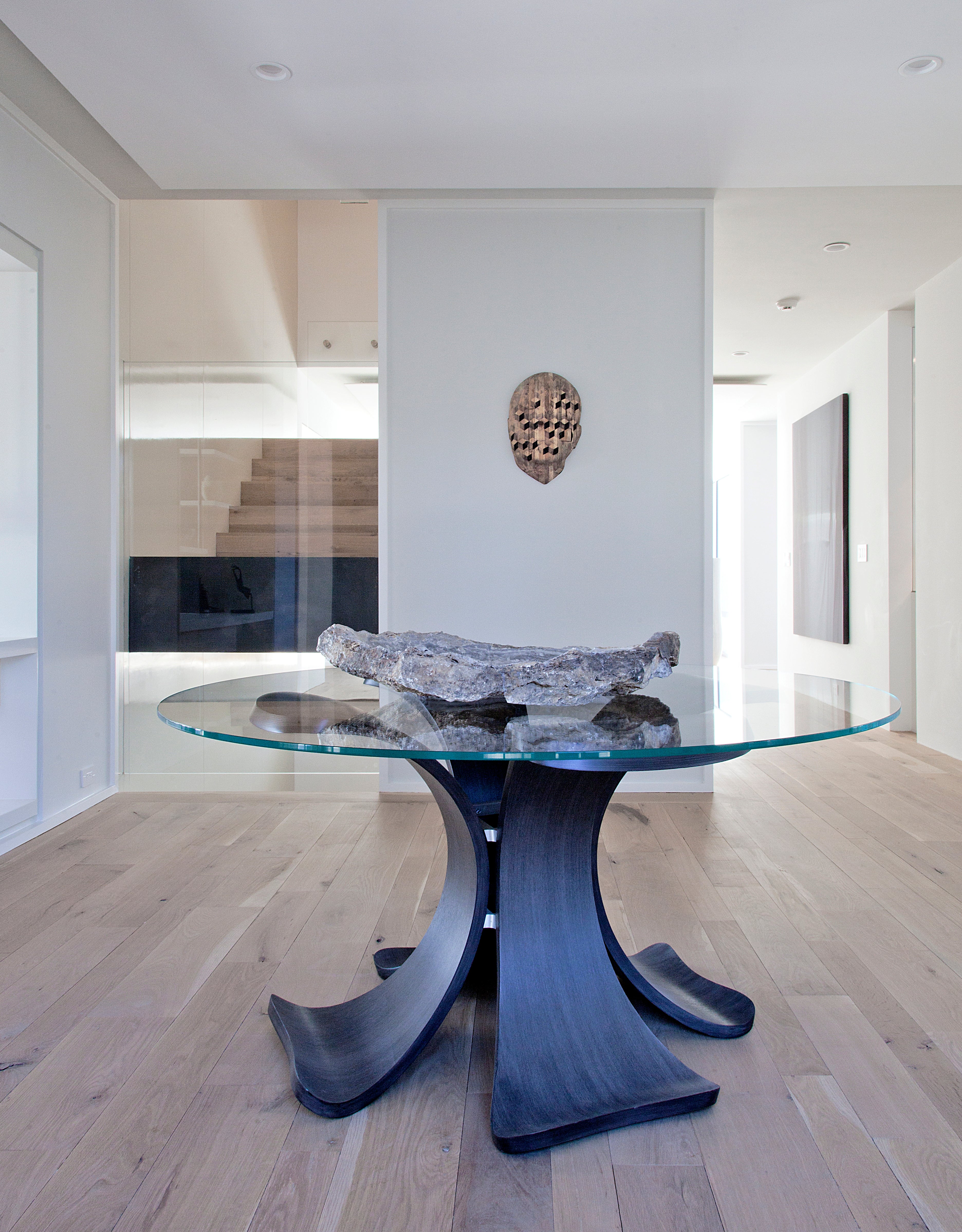 This stunning “Orchid” glass dining table with a blackened oak base is a remarkable addition to your home, offering great character and visual appeal. At 52 inches in diameter the table comfortably seats four to six and can also be ordered in 66 and