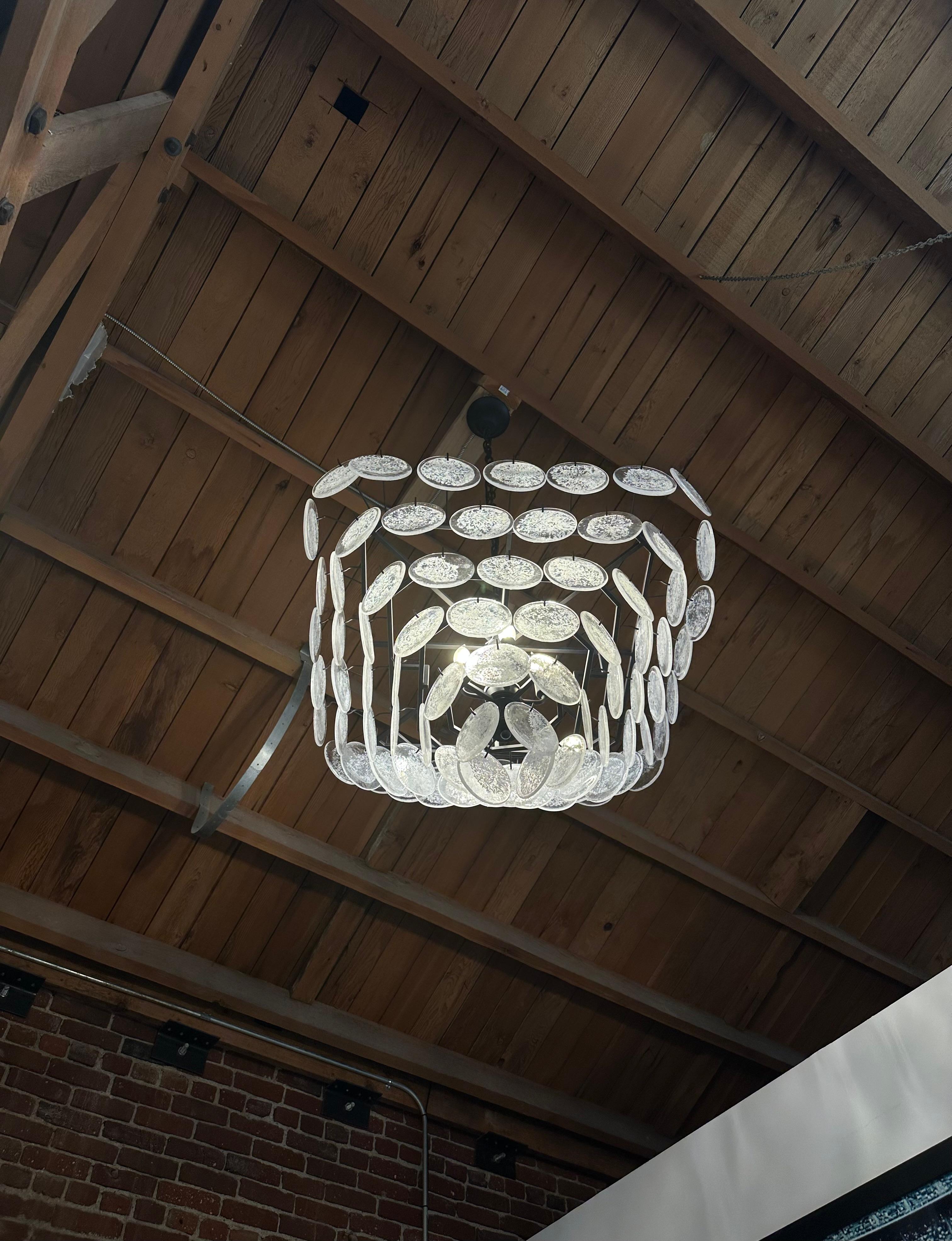 GLASS DISC FRINGE CHANDELIER

A lot of fun and just a bit flirty, this chandelier features overlapping discs of glass suspended from minimally finished metal.

Overall Dimensions: 32