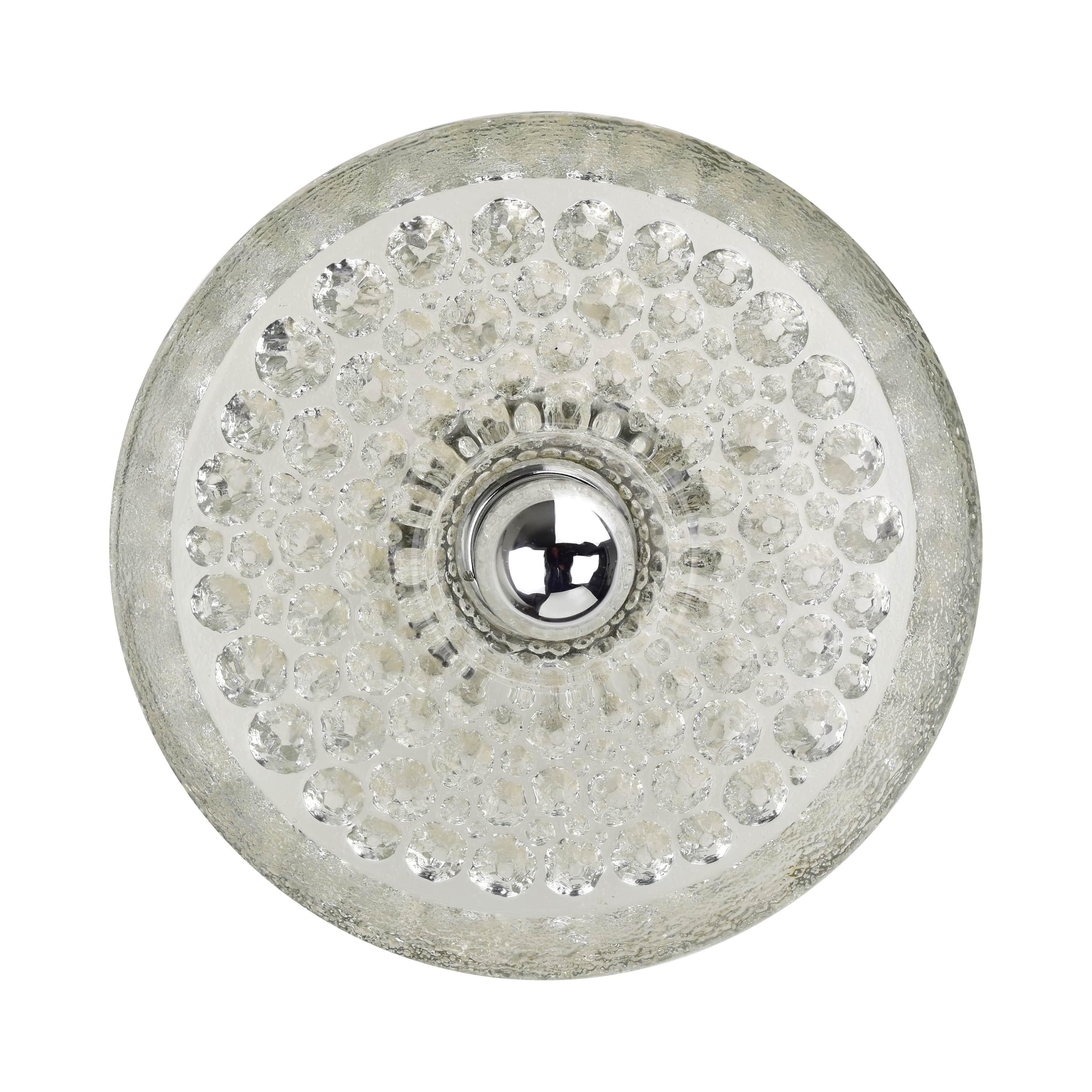 Vintage mid century modern disc shaped wall sconce in sculptural glass on a chrome frame made by by Peill & Putzler circa 1970s. Likely designed by Koch & Lowy. A true statement piece and eye-catching item. 

The clear design with modern materials