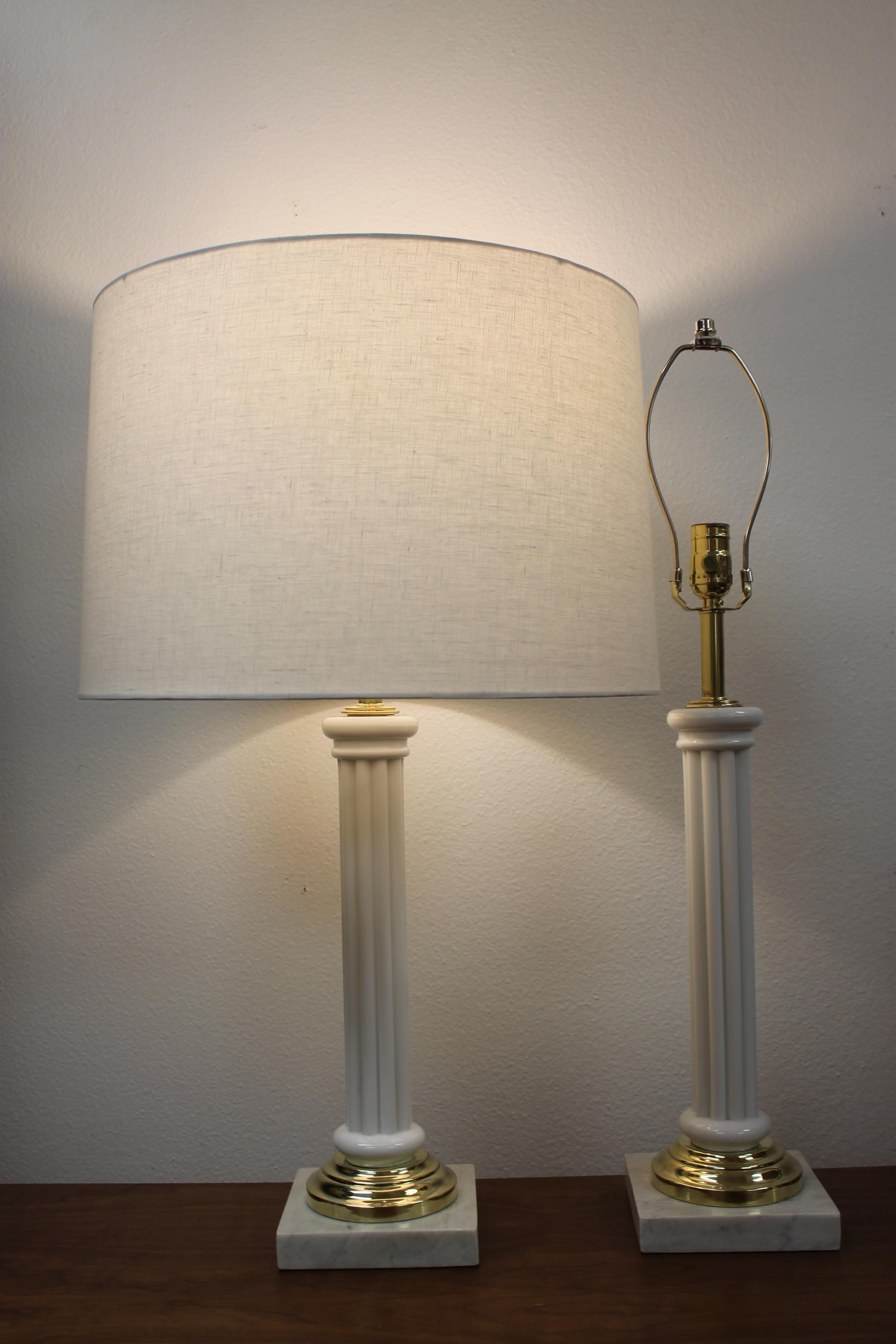 Pair of glass Empire column lamps on brass and marble bases. Glass column portion is 13.75” high. Marble base is 6” wide, 6” deep and 1” high. Total height from base to the bottom of socket is 20”. Lamps have been professionally rewired for 3-way