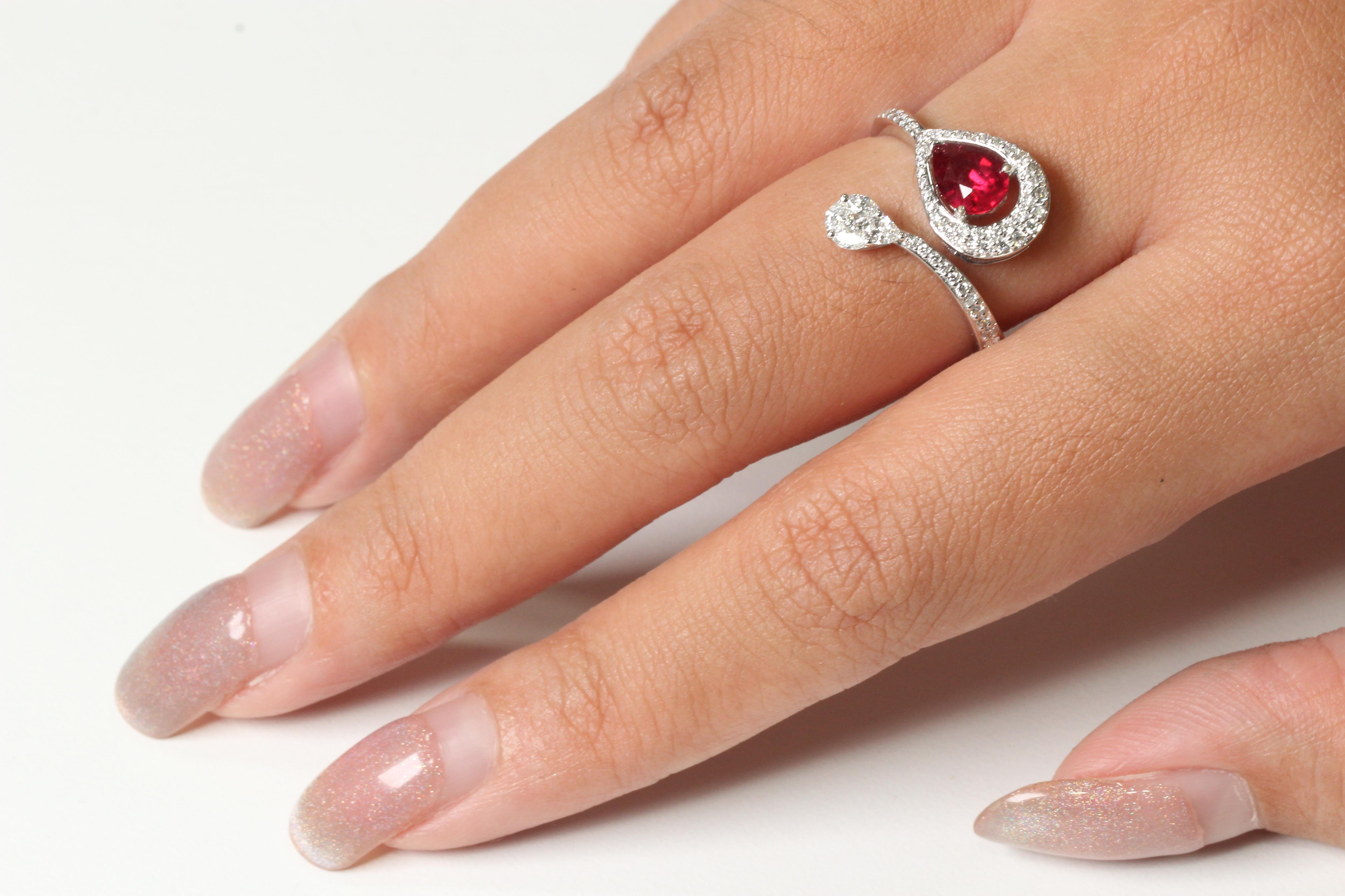 With this ring, you can be sure to grab everyone's attention. This piece is made up of a glass filled ruby stone and diamond stones in an antique style setting. The combination of these materials and the design of this ring make it stand out from