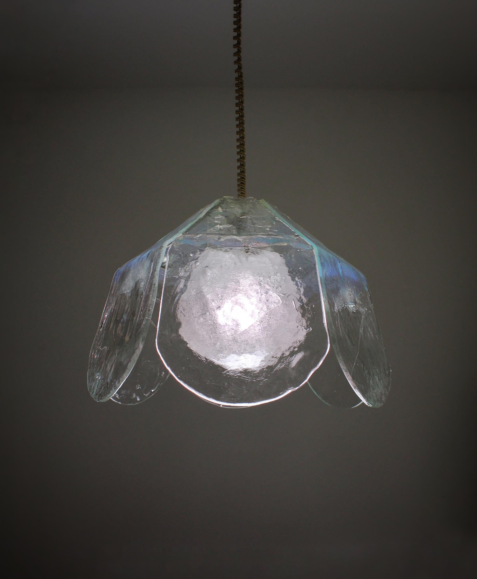 Large glass pendant lamp, designed by Carlo Nason for Mazzega during the 1970s. This exceptional lamp is made of 6 rough glass plates and a “peleguso” glass globe in the center. Together they form a flower like shape. A warm and magical light is