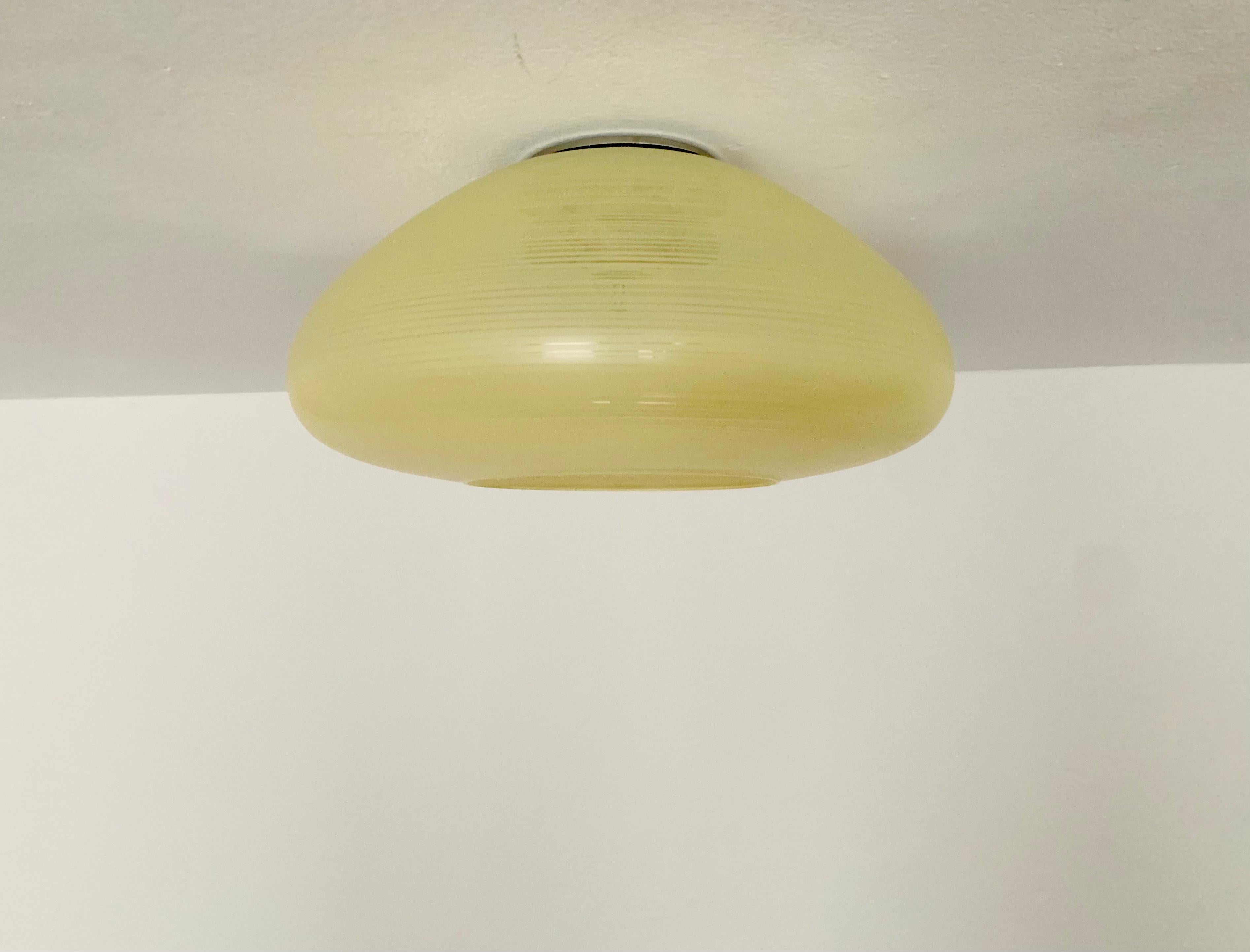 Exceptionally beautiful and very rare ceiling lamp from the 1950s.
The great stripe pattern spreads a very pleasant light and makes the lamp very special.
Very fine and beautiful design which fits wonderfully into any room.
Very rare in this