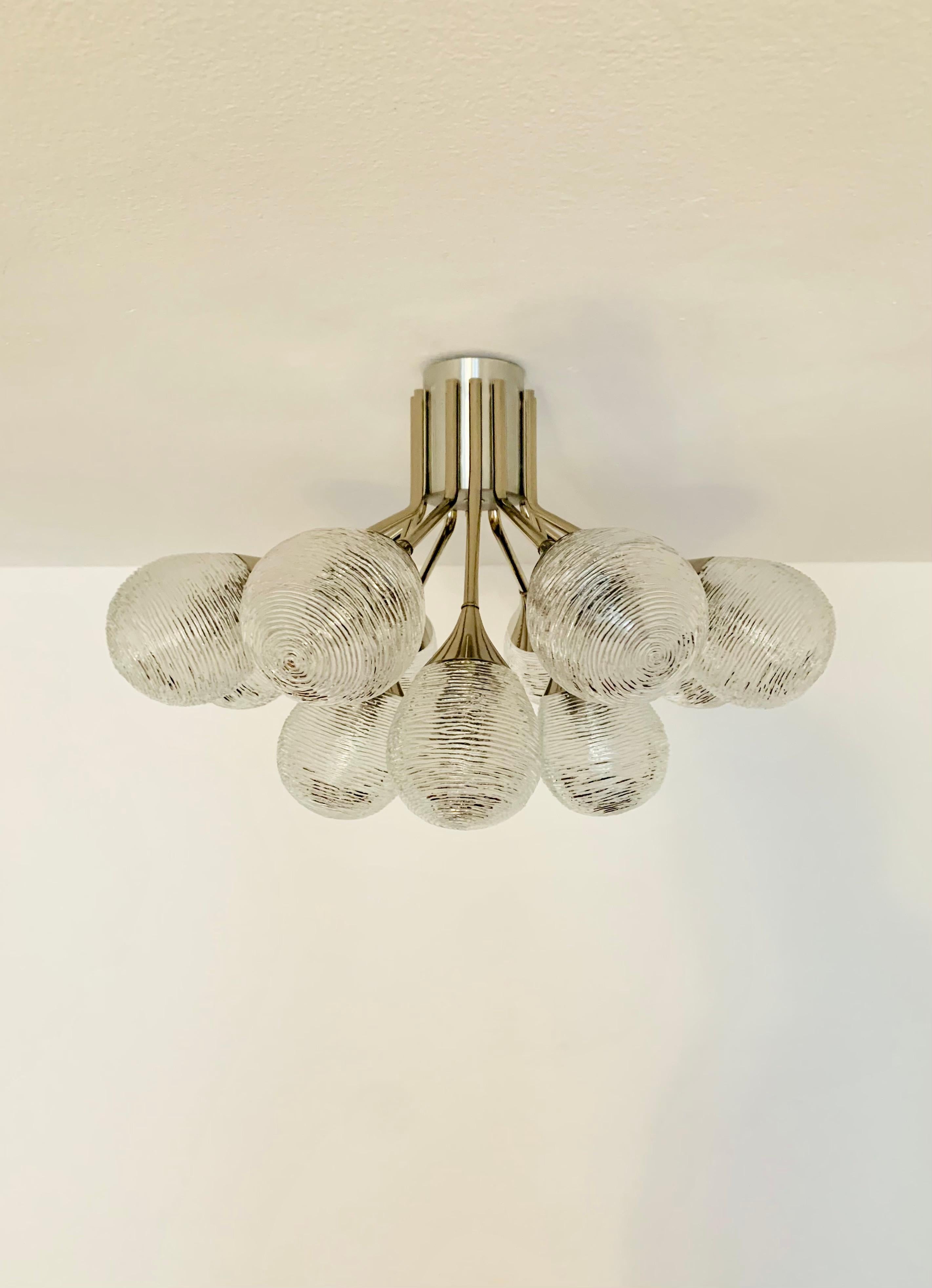 Chromed Sputnik chandelier from the 1960s.
The 12 special glasses spread a sparkling light.
The lamp has a very high quality finish.
Very contemporary design with a fantastic look.

Condition:

Very good vintage condition with slight signs of wear