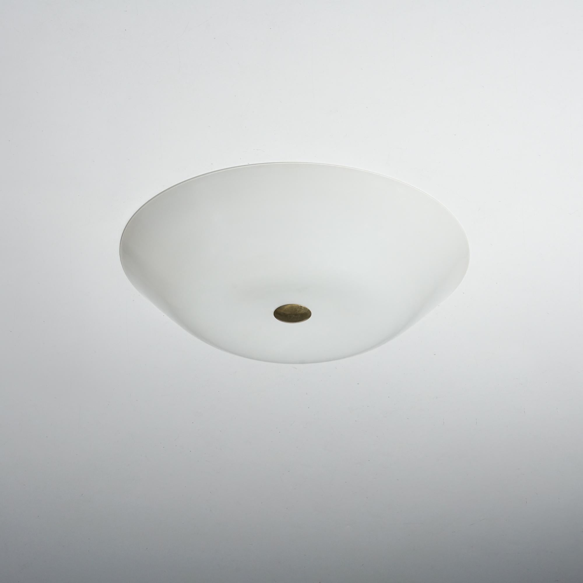 Flush mount, design Lisa Johansson-Pape, manufactured by Orno Oy, 1950s. Glass shade with brass detail. Marked. Good vintage condition, minor patina consistent with age and use. 

Lisa Johansson-Pape is one of the most important Finnish lighting