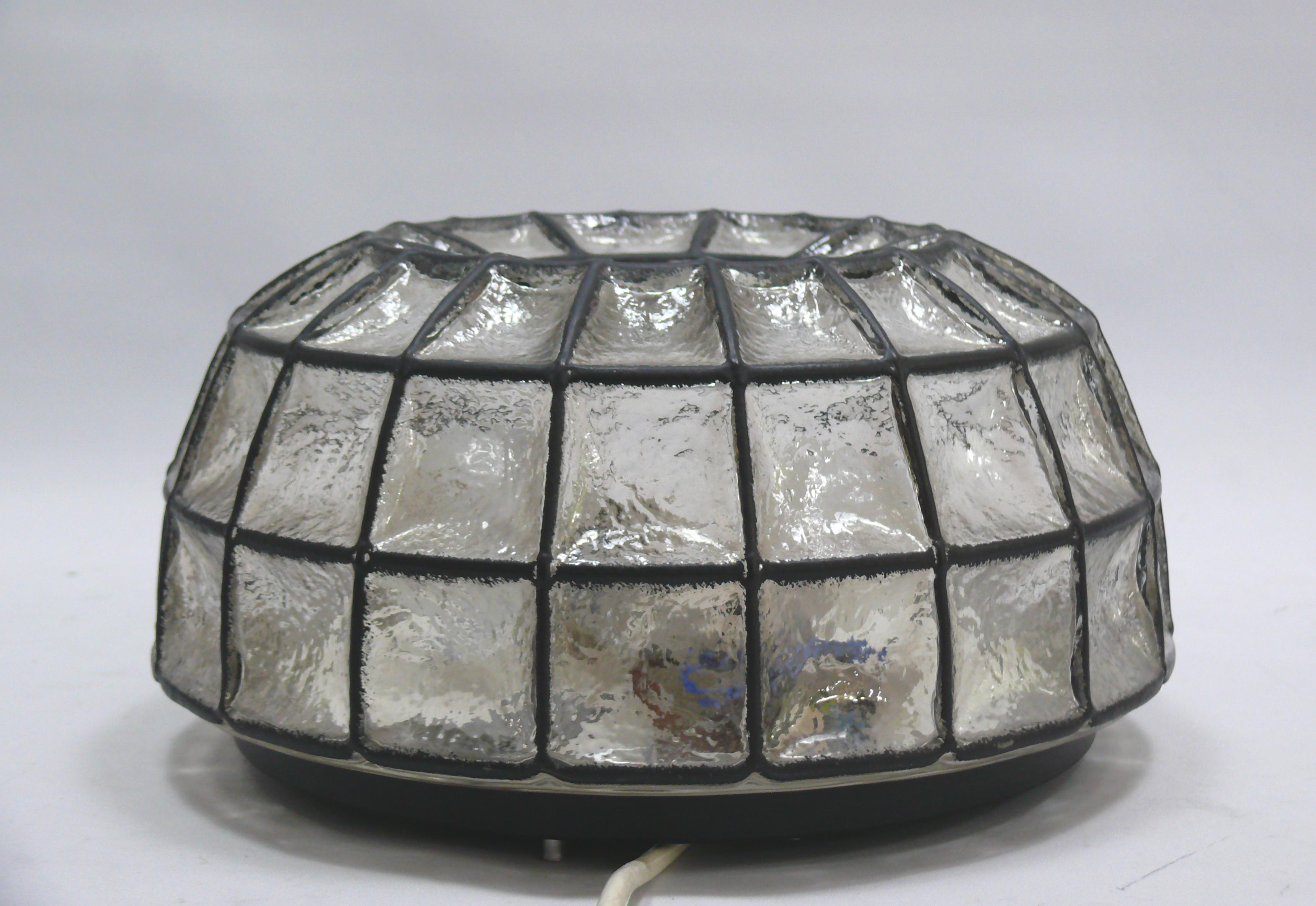 Round ceiling light from the 1970s by the traditional company Glashütte Limburg in the style of old leaded glass (iron ring look): The glass dome is made from a single piece, but the glass has a black stripe along the edges, separating the resulting