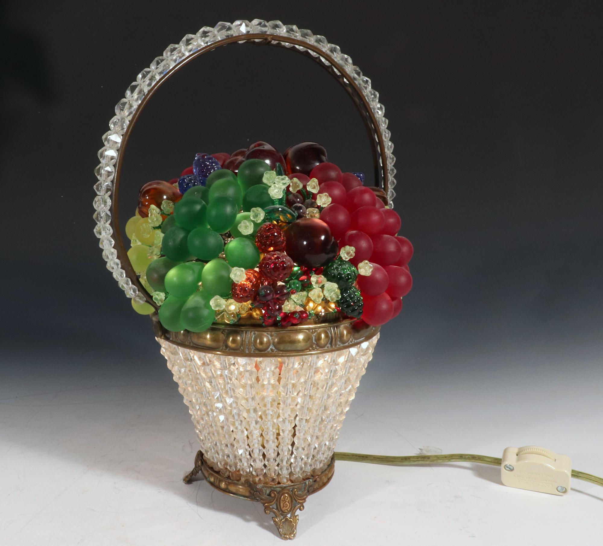 Super Cute & Fun

Czechoslovakian Glass Fruit Beaded Basket Lamp,
1920-1930s.

The glass basket with beaded base and handle has a removable top filled with glass fruit. The basket is electrified and is on working order producing a charming glow