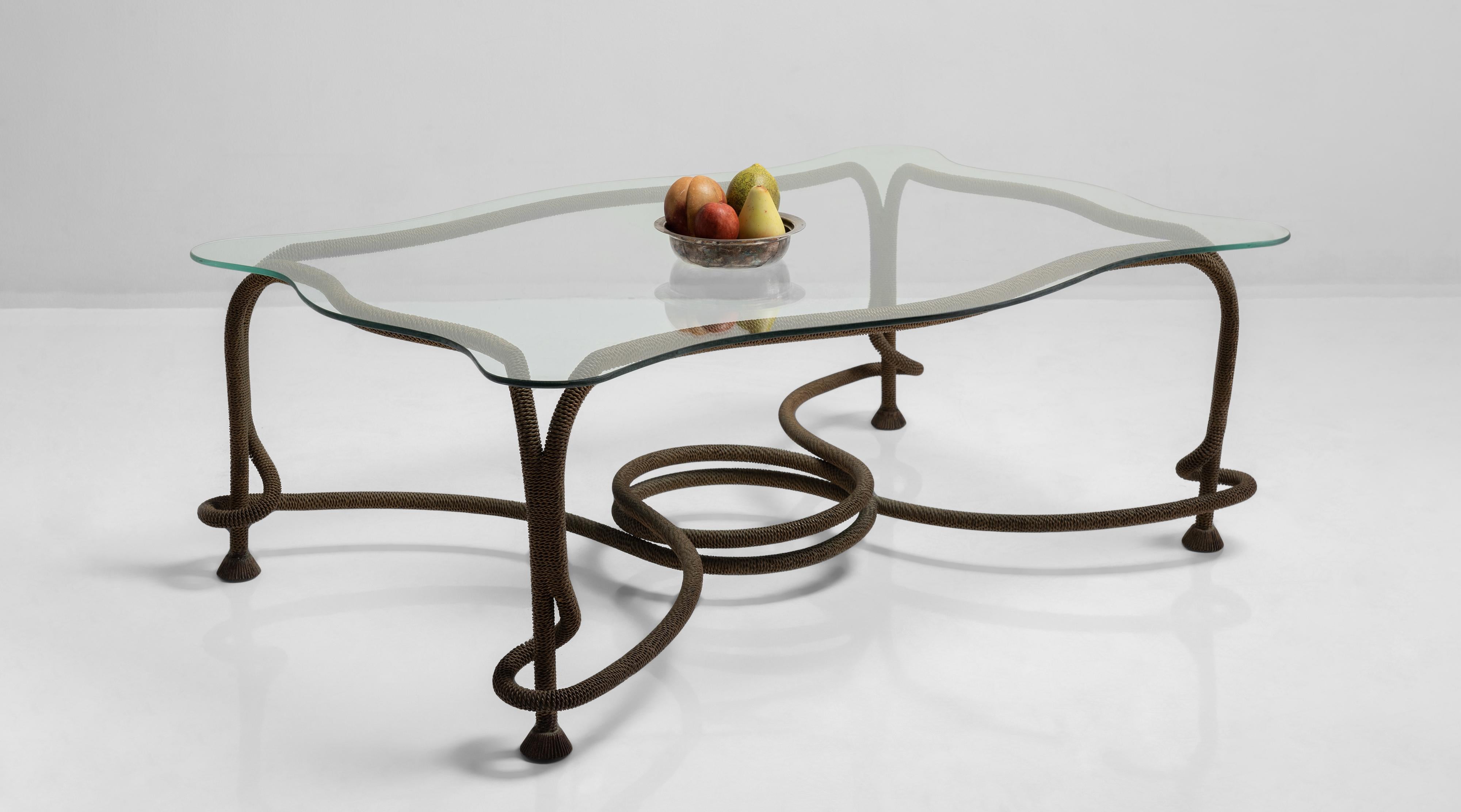 Glass and gilded metal coffee table by Emilio Rey, Spain, circa 1970.

Decorative, curved glass top on gilt metal base in the form of twisted tasseled rope.