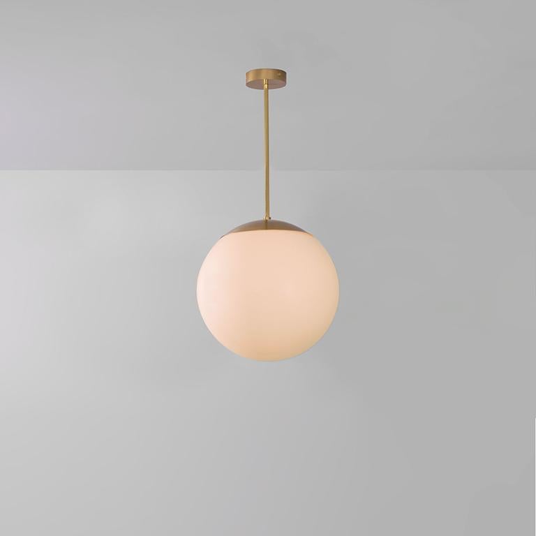 Glass globe opal 40 pendant light by Schwung
Dimensions: W 40 x D 40 x H 85 cm
Materials: Natural brass, hand blown glass globes

Finishes available: Black gunmetal, polished nickel

Schwung is a German word, and loosely defined, means energy or