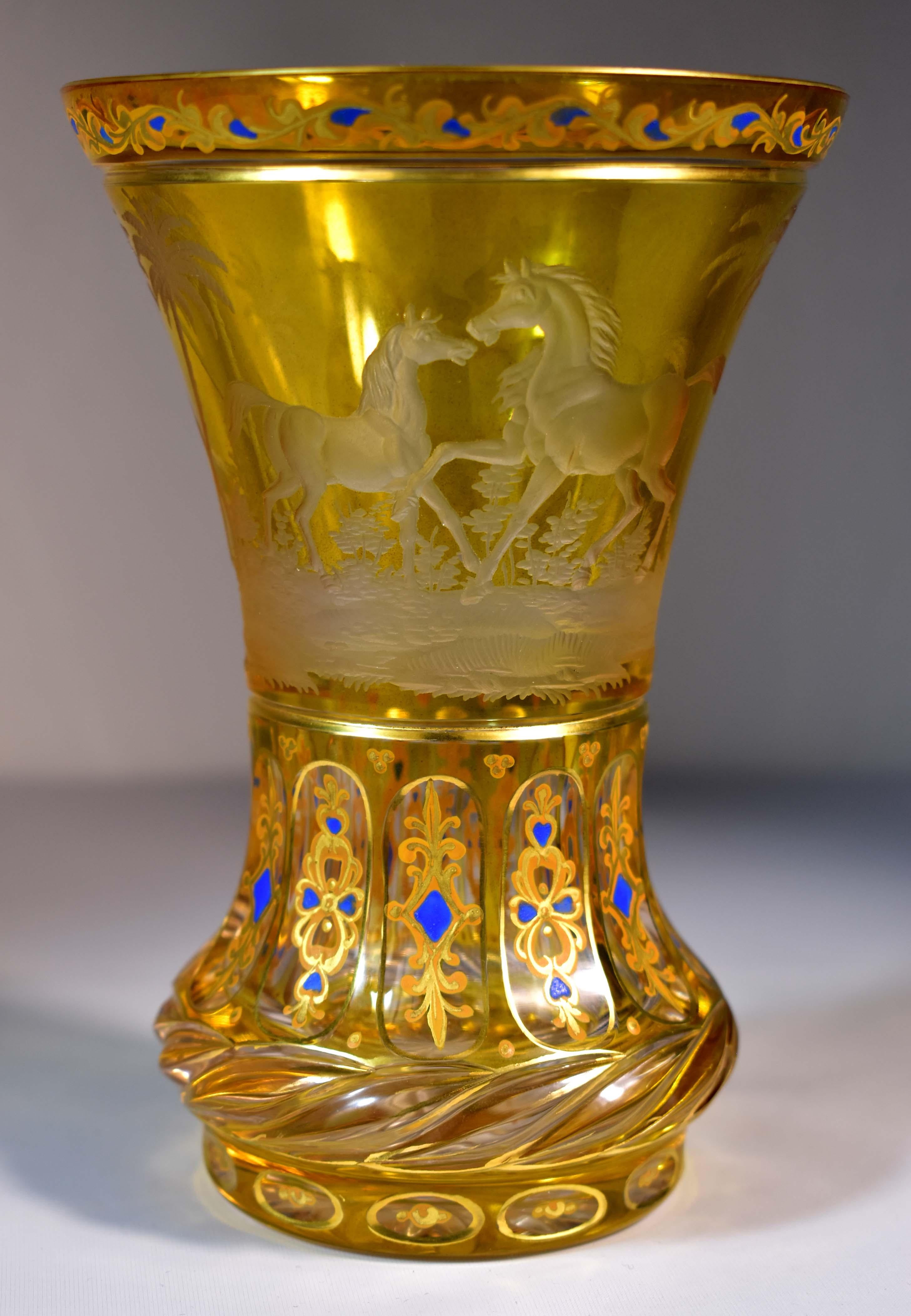 A beautiful cut cup from the turn of the 19th-20th century, Maybe the first half of the 20th century. It is a clear glass with a yellow lazure, The goblet is cut, decorated with engraving and gilded painting. The engraving is with the motif of