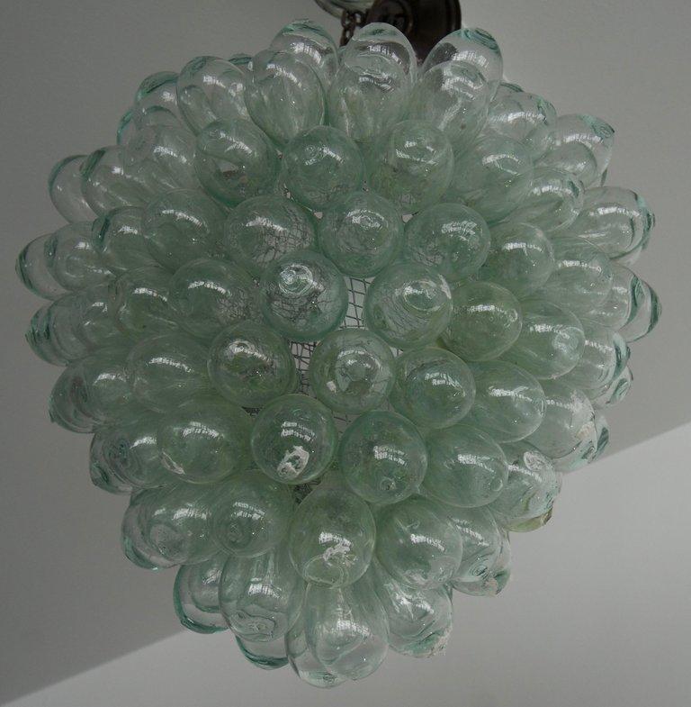 This stylish and chic chandelier seems to be a stylized cluster of grapes and if fabricated from hand blown pieces of glass.

Note: Requires one Edison based light bulb.

Note: Dimensions of the cluster itself are 15