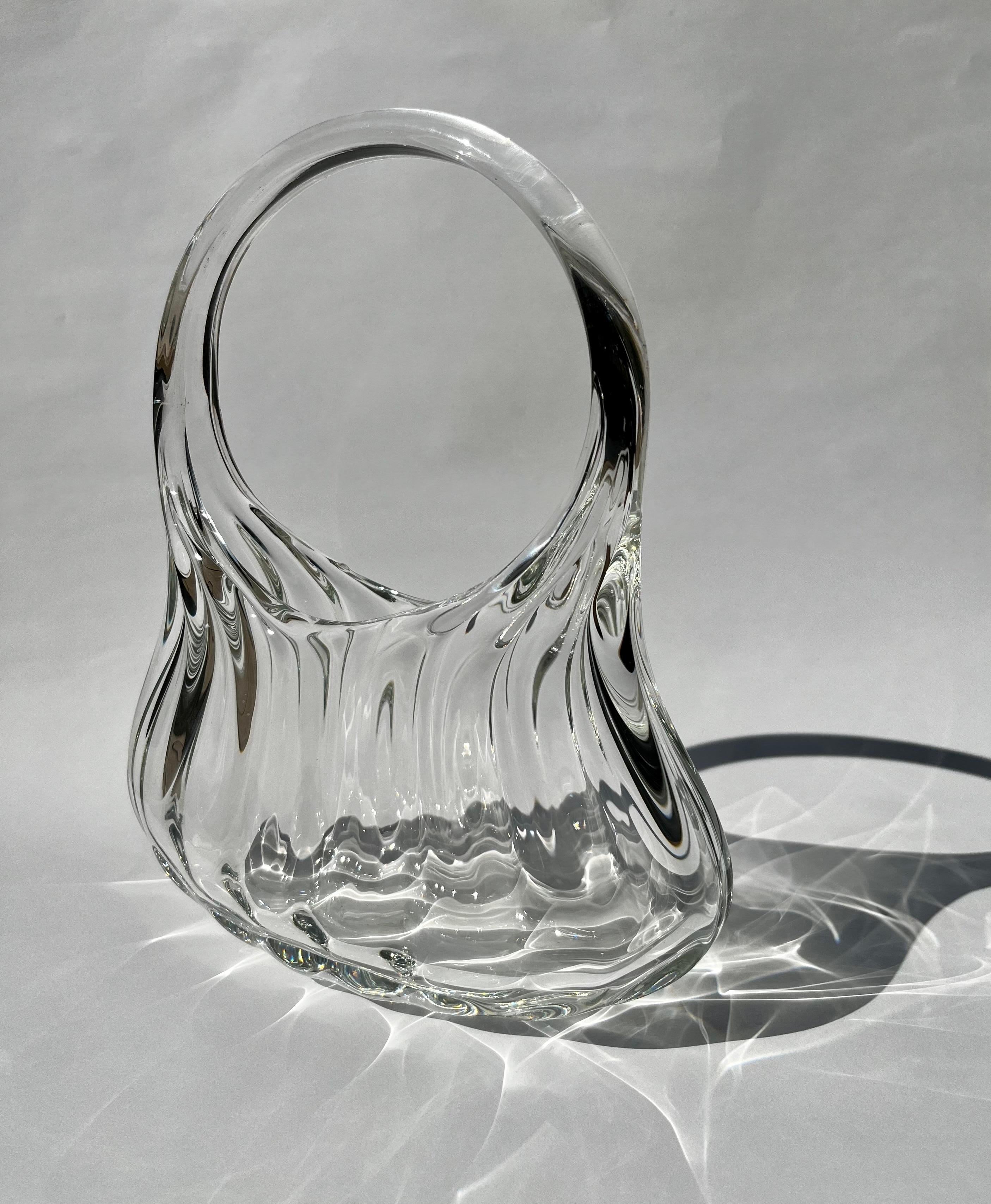 This bag was designed to maximize the refractory quality of glass. It featured soft wavy ridges on it’s surface which bend, throw and magnify light in heavenly arcs and rainbows. No other material shapes and manipulates light quite like glass does,