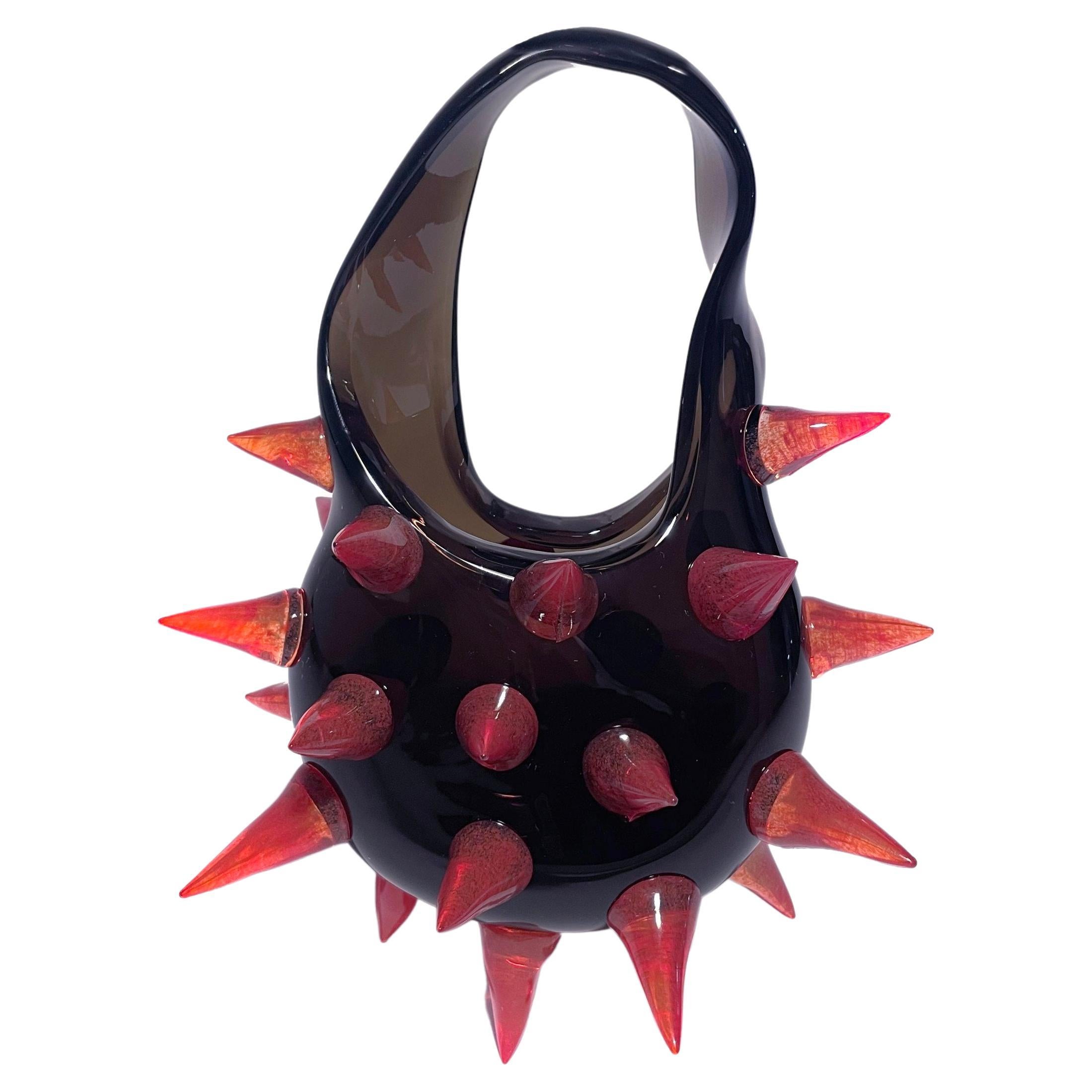 Dark, grey, green bag with semi-sharp red spikes. If I'm being honest, this is the direction I'd like to take this bag project. I want to make them more sculptural, more expressive, more avant-garde. I don't need to appeal to the masses. I'd rather