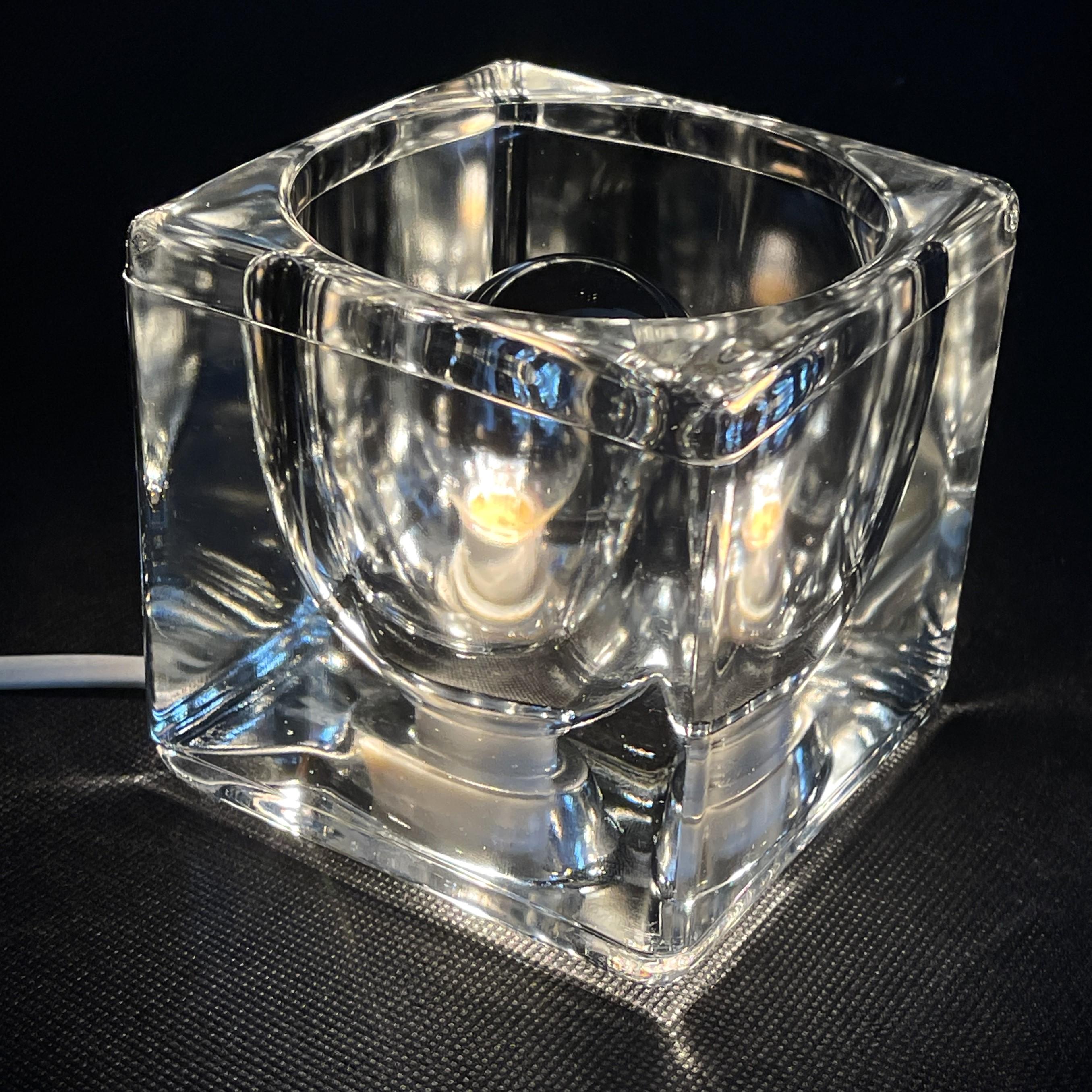 desk lamp ice glass by Peill & Putzler,  1970s.

The designer lamp is a real classic from the 70s. The lounge lamp from Peill & Putzler is made of high-quality glass in the shape of an ice cube. The clear glass cubes create a beautiful diffusion of