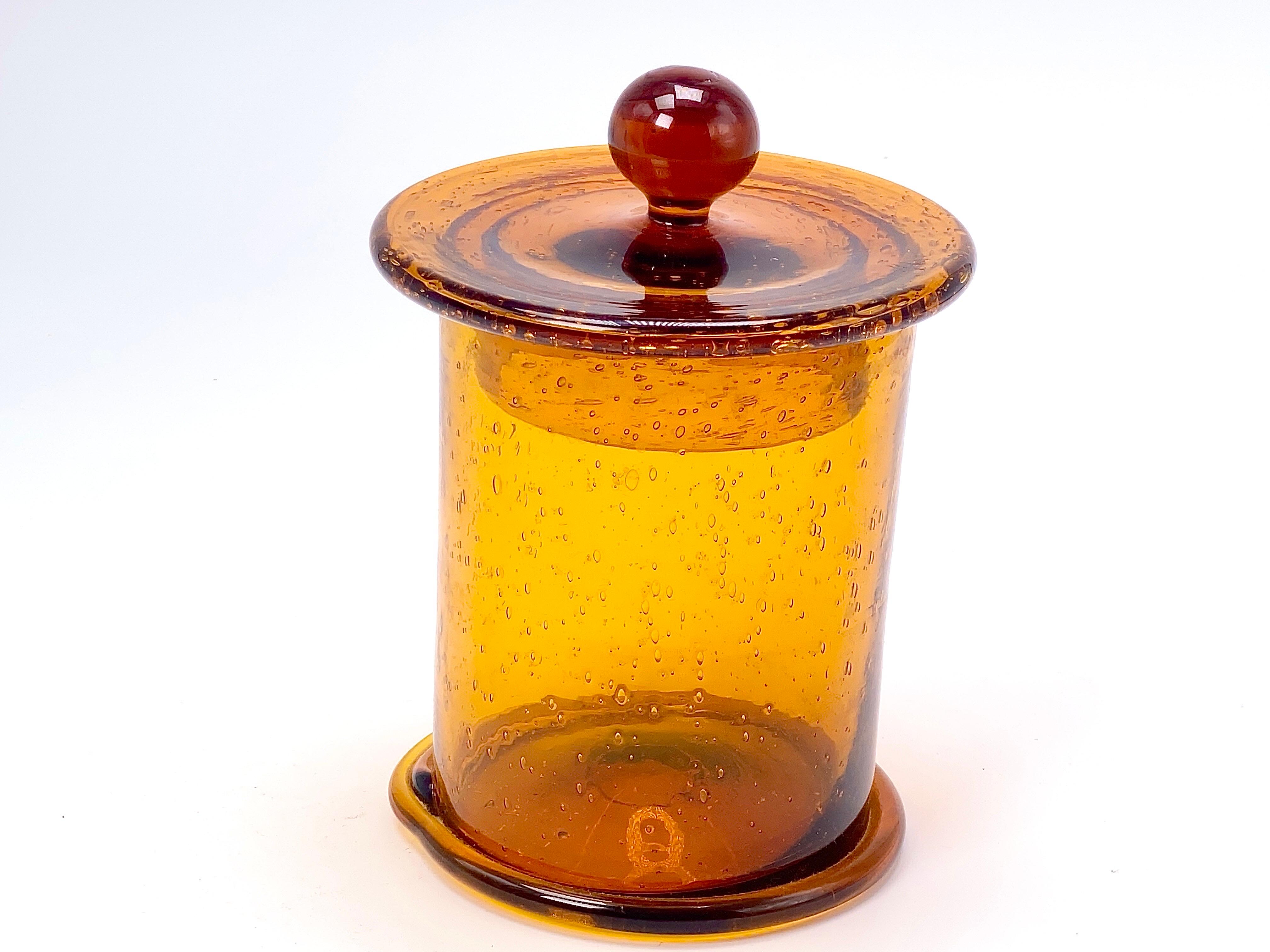This Jar is in art glass, made in Biot in France, Circa 1970. It is in a brown color and good condition.