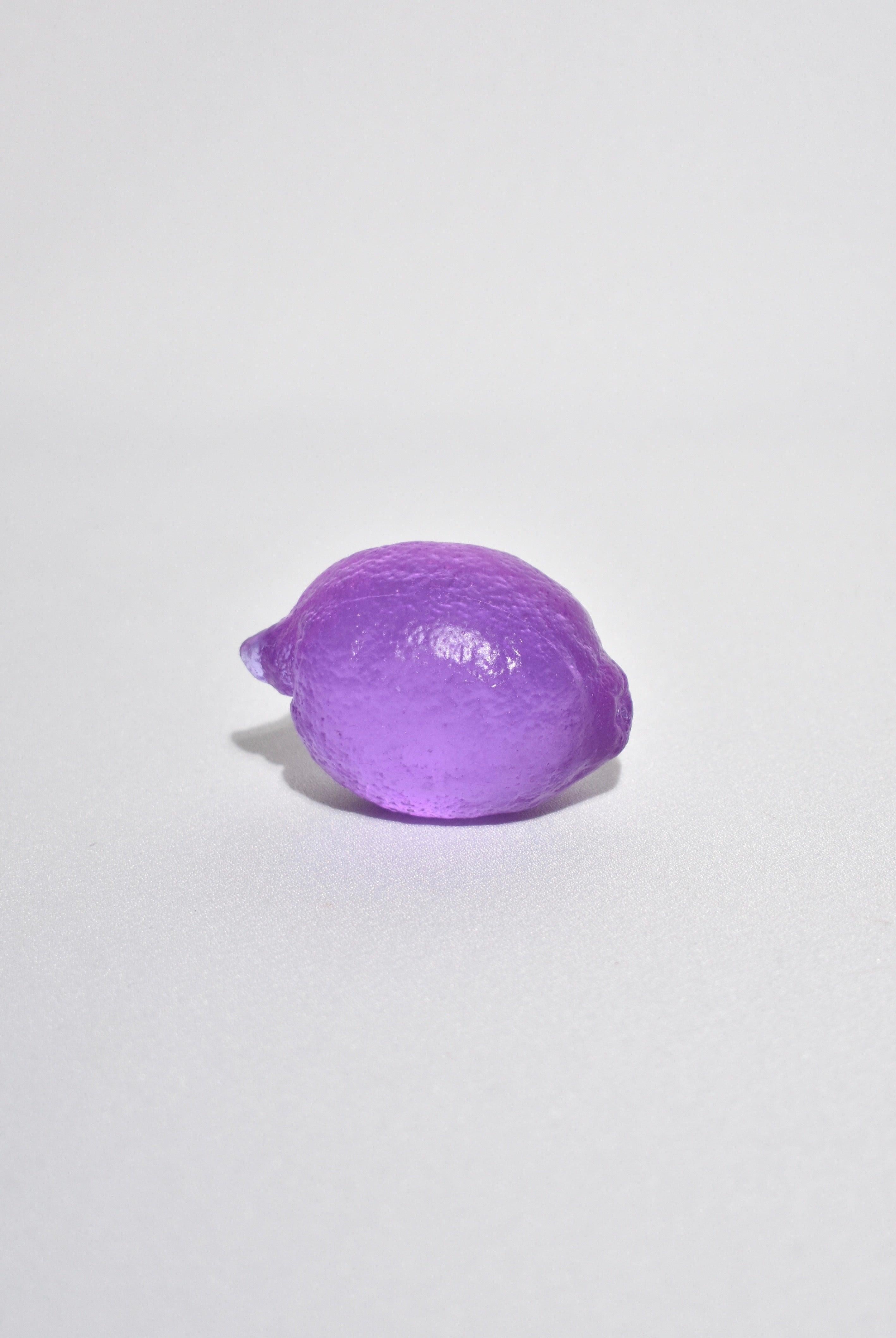 Casted glass lemon in dichroic lilac by Devon Made inspired by blown glass fruit makers and collectors from the 1960's. The light playful approach to everyday fruit is contrasted with the heaviness of the crystal glass, a unique material that