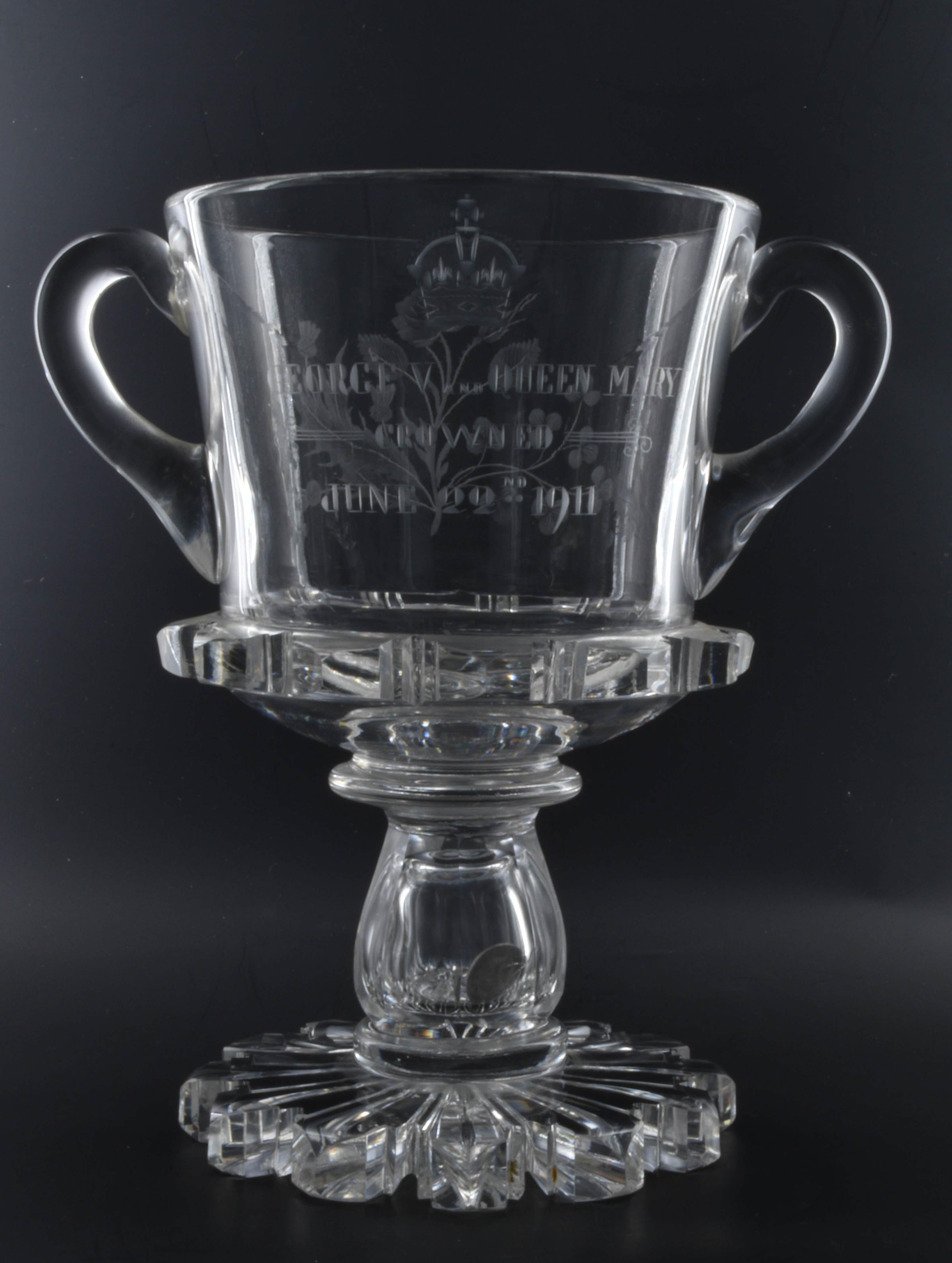 Lead crystal Loving cup, Coronation of George V and Queen Mary, June 22nd, 1911. 

Made for the retailer Thomas Goode. A traditional threepenny bit is set in the hollow stem, a nice indication of the skill of the glass-blower.


George V was born on