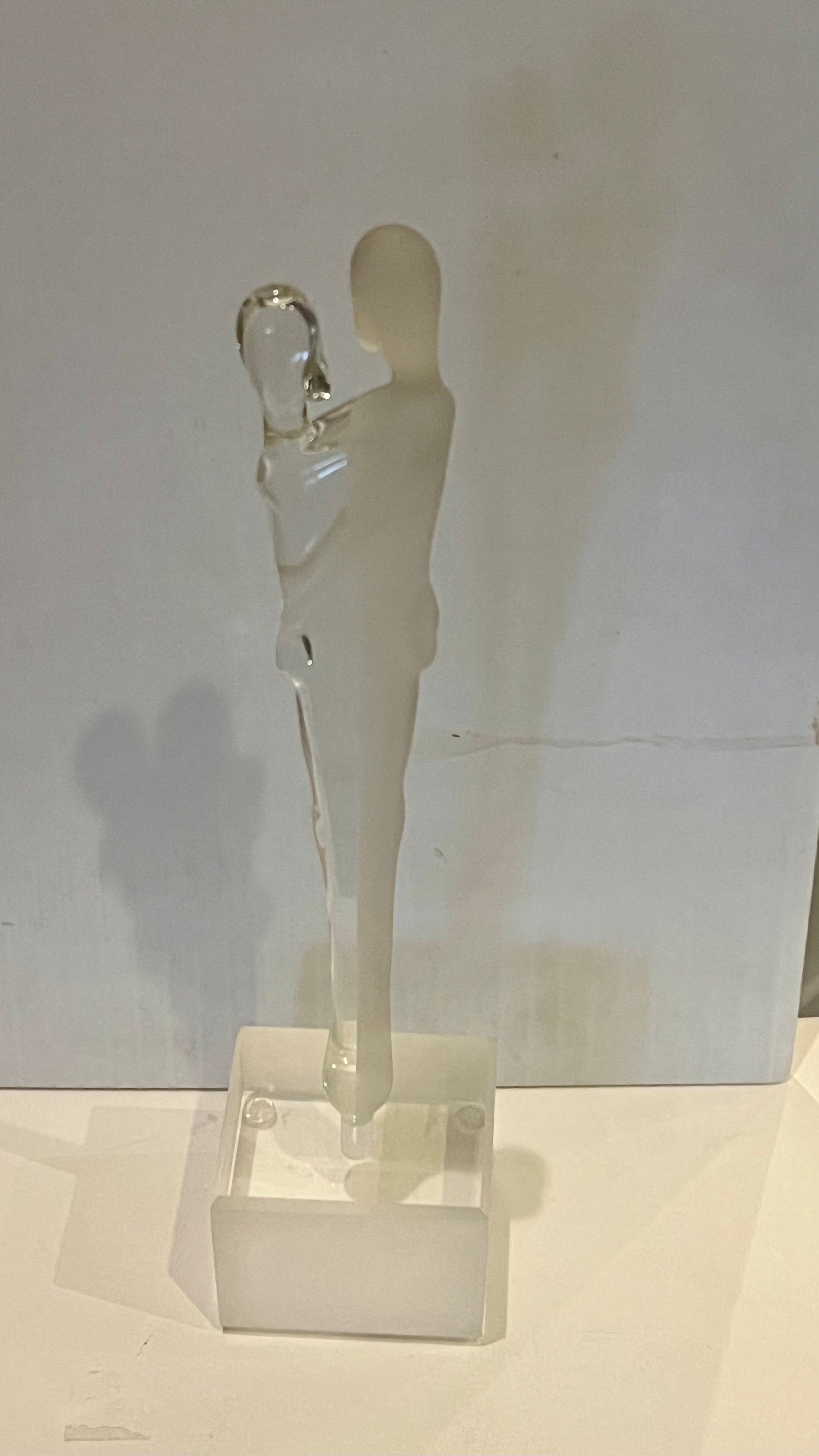 Elegant beautiful frosted & clear glass lovers sculpture sitting on solid lucite base excellent condition signed on the stem as shown.