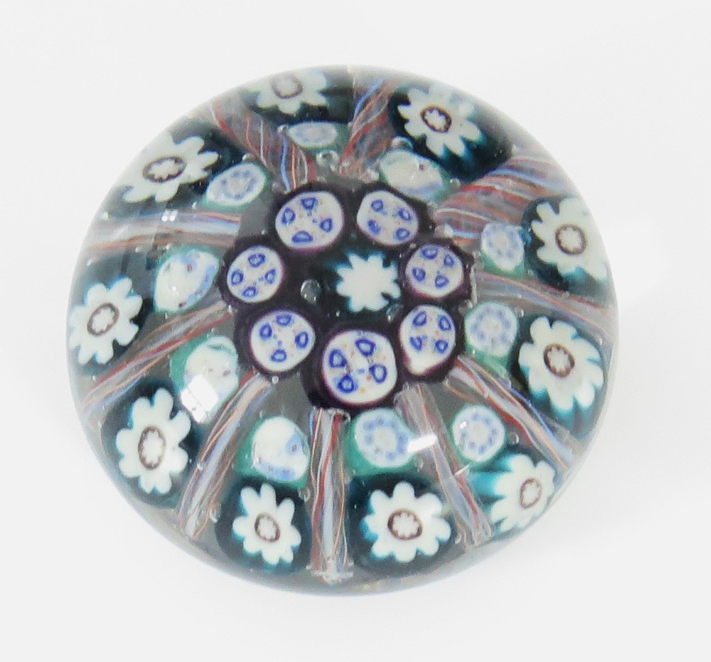 This is a beautiful handblown Glass Millefiori Paperweight by Vasart, Scotland, Circa 1950s. 

This paperweight is handmade with a Millefiori, ten spoke radial cane design. 
having Latticino Spokes. The predominant colours are red, green, blue and
