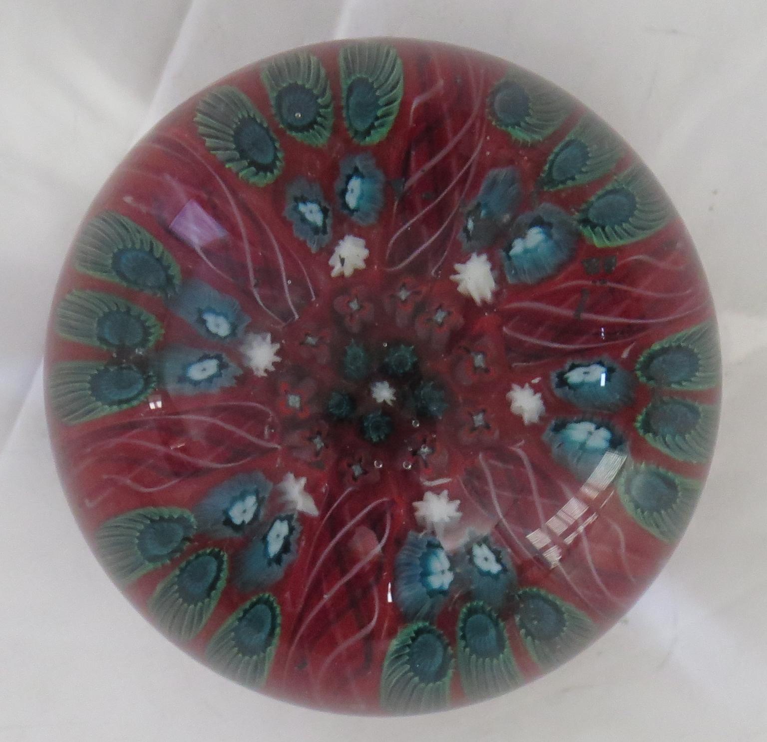 This is a beautiful handblown Glass Millefiori Paperweight by Vasart, Scotland, Circa 1960 or slightly earlier back to the 1950's.

This paperweight is handmade with a Millefiori, six spoke radial cane design. 
having Latticino Spokes. The