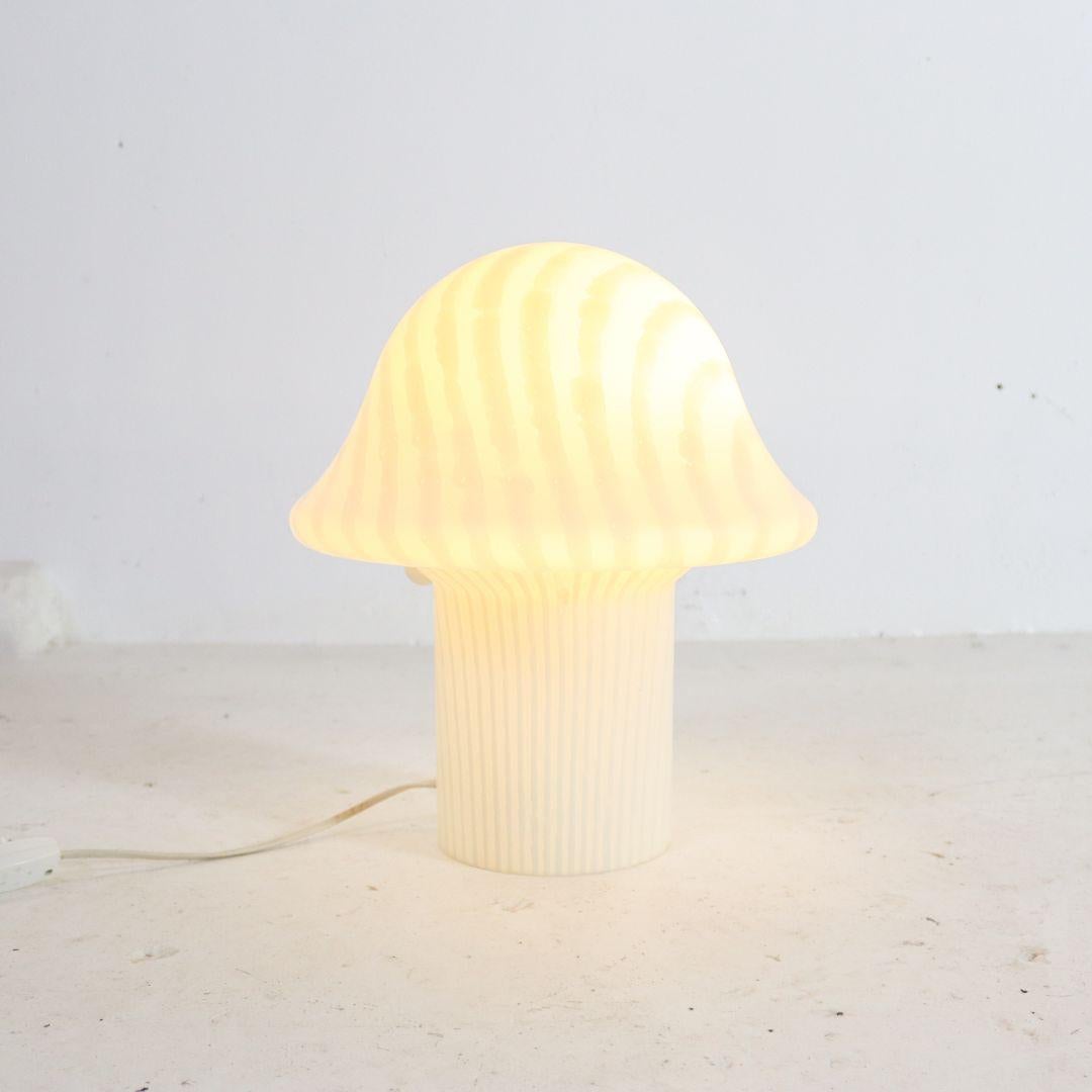 Large 1970s 'mushroom' table lamp by Peil & Putzler. The table lamp is made from a single mouth-blown piece of crystal glass with a striped zebra print and has the shape of a typical Mid-Century mushroom. Standard E27 fitting, tested and working.