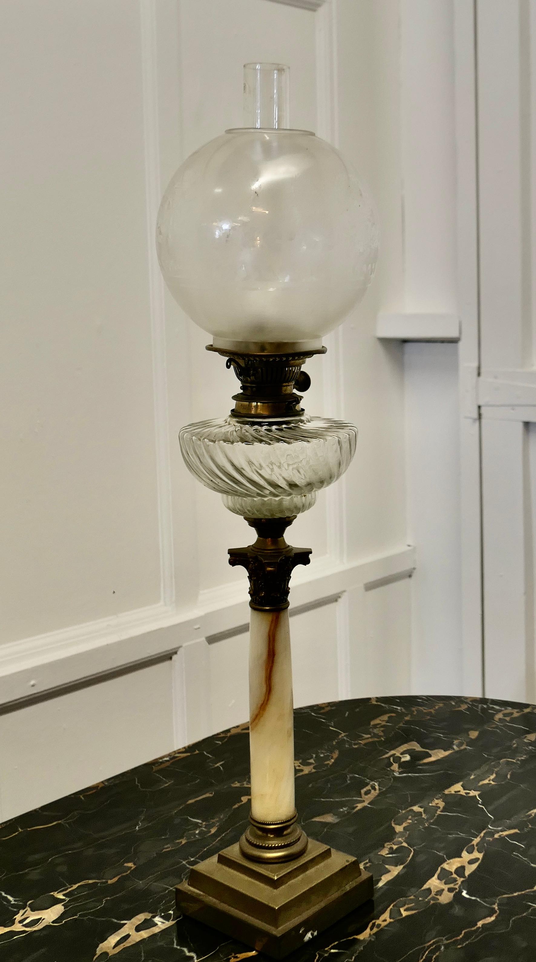 Glass Oil Lamp on Marble Column with a Stepped Brass Base

A pretty Glass lamp set on a marble  and  brass base, the lamp is a great looking piece, it has a glass chimney and a burner but I cannot guarantee if it is in working condition 

The lamp 