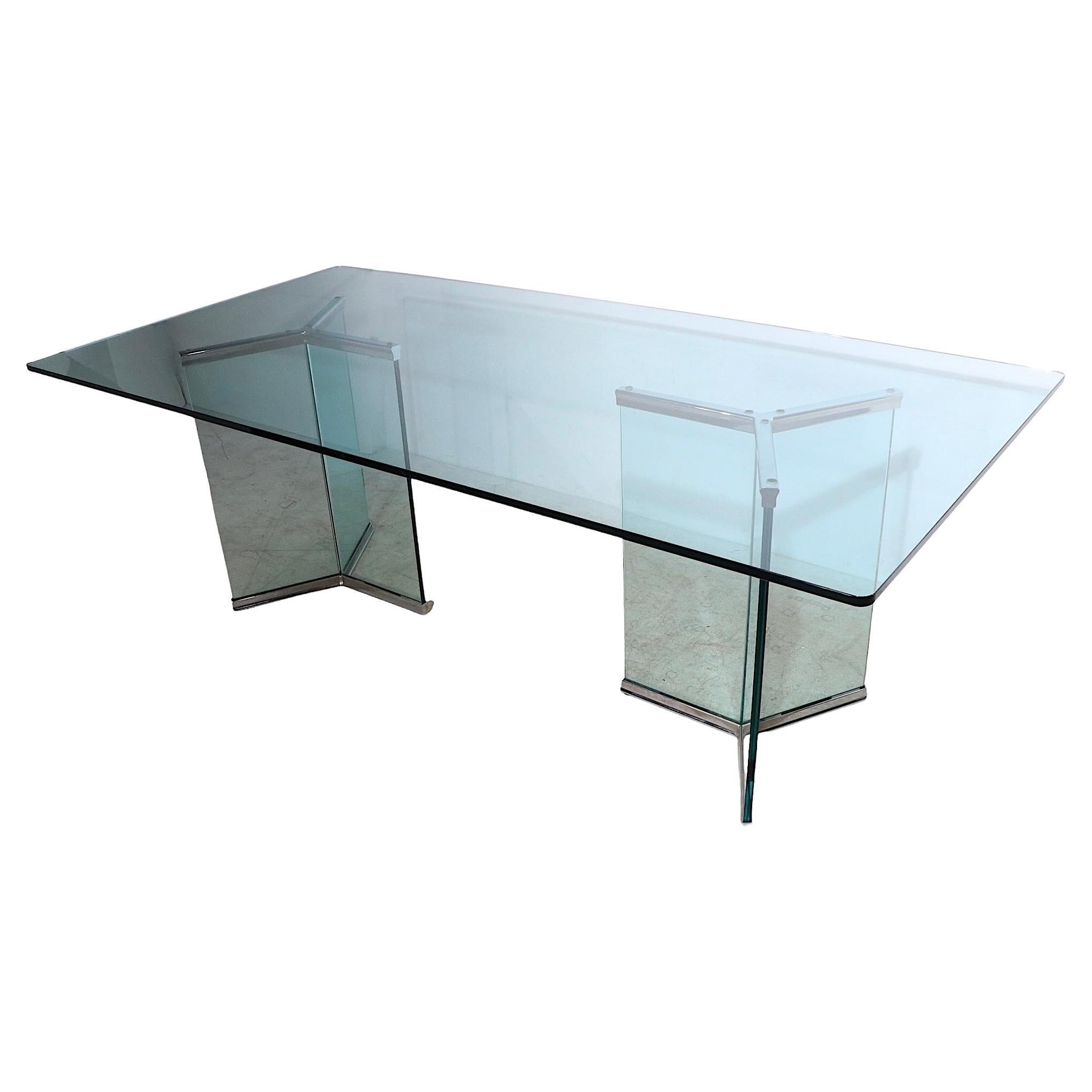 Massive glass on glass dining, conference table designed by Irving Rosen, for Pace Collection, circa 1970's. The table features a large ( 84 x 42 x .75 inch ) rectangular top, which rests on two glass and chrome supports, each also constructed of