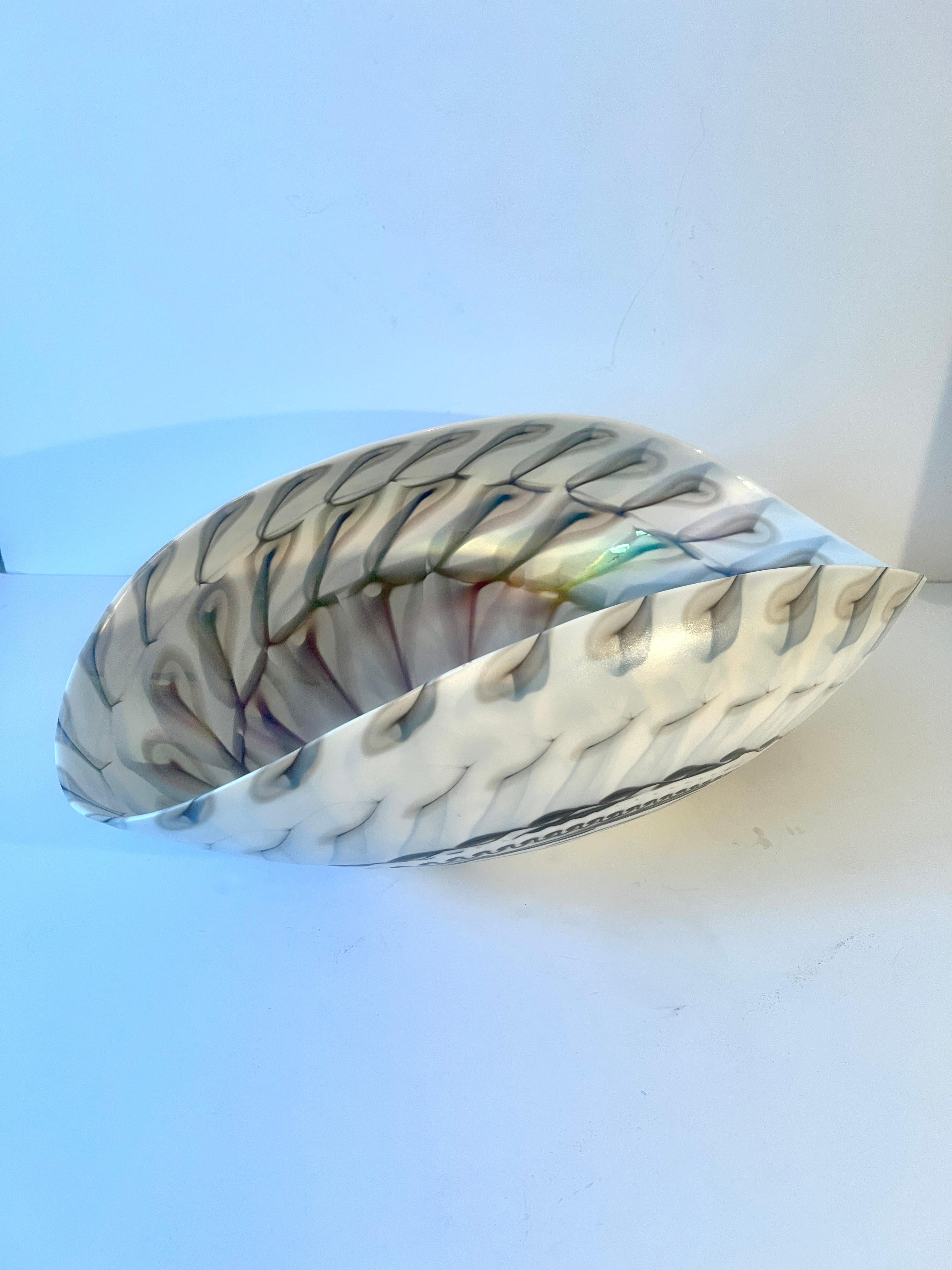 A very large Art glass or Porcelain Bowl - the design looks very much like a shell and would work nicely as a centerpiece or decorative piece on a cocktail table or console.

Also a great piece to serve chips or use at the bar.

The size and design