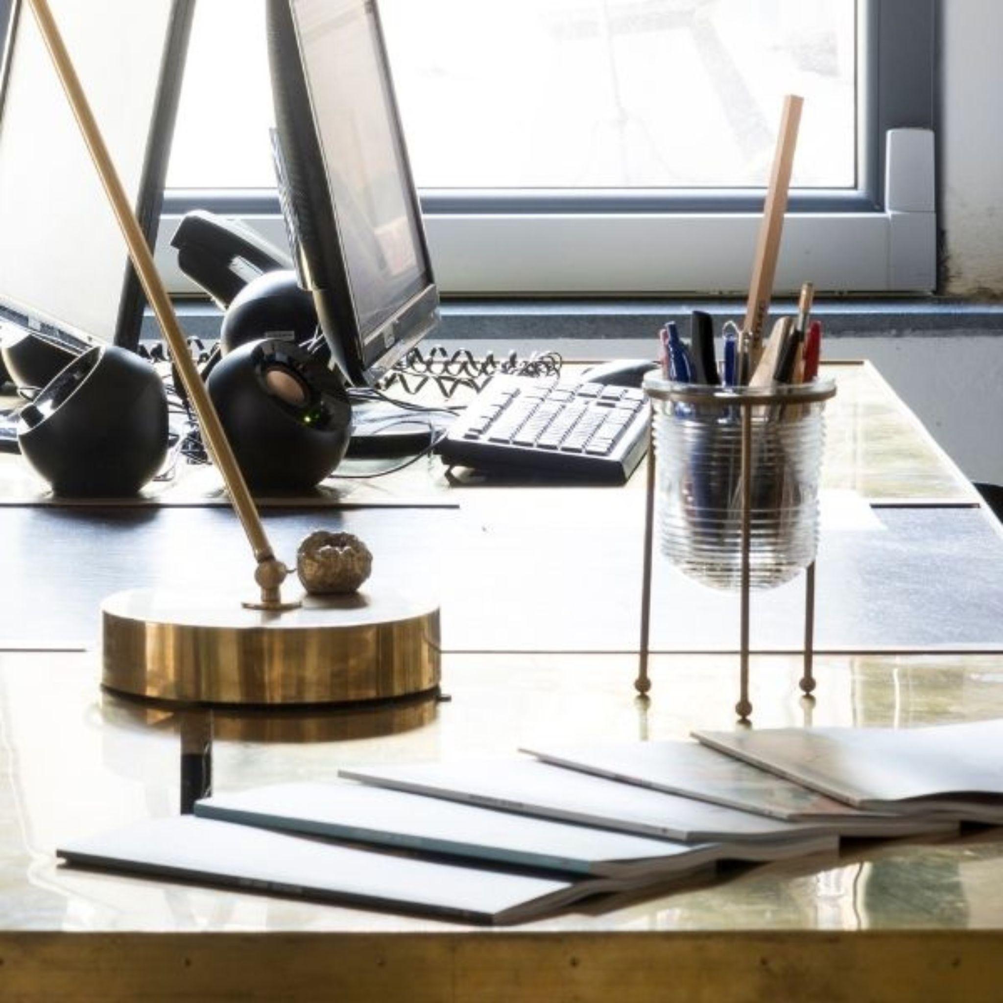 Add some sophistication and organization to your desk with our glass pen holder featuring a beautiful brass structure. Perfect for holding pens, pencils, and other small office supplies, this elegant accessory will elevate your workspace. Shop now